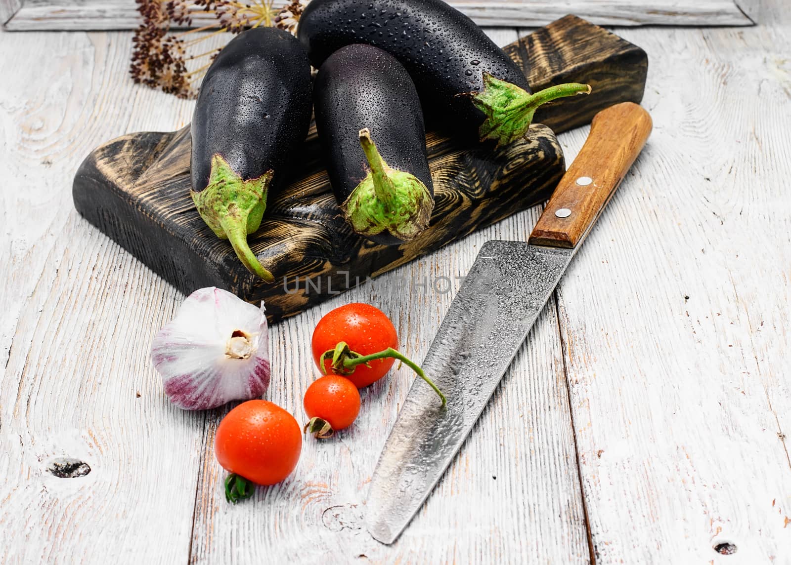 Harvest vegetables aubergine on wooden background in rustic style