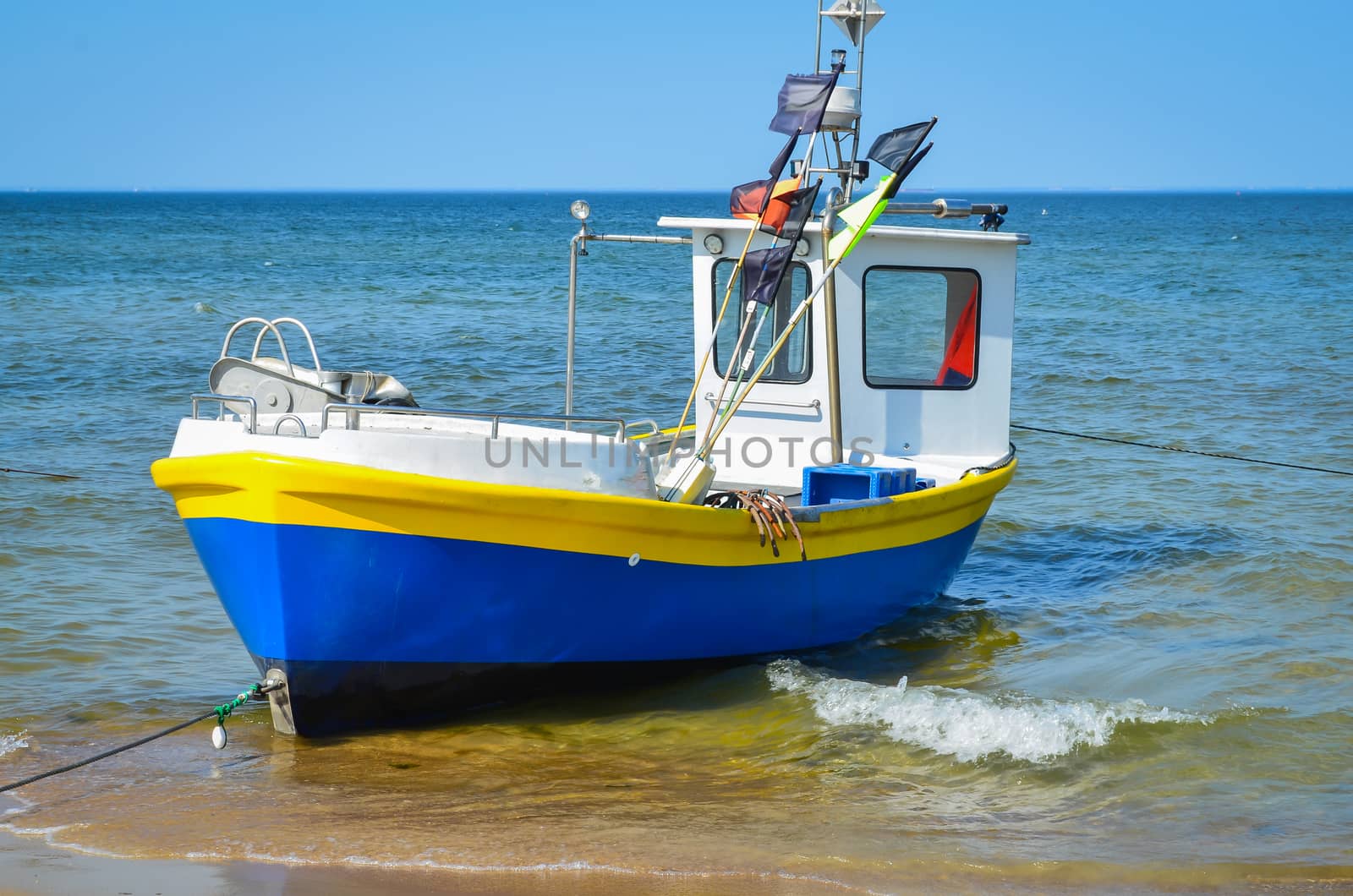 White yellow blue   fishing boat on alongshore