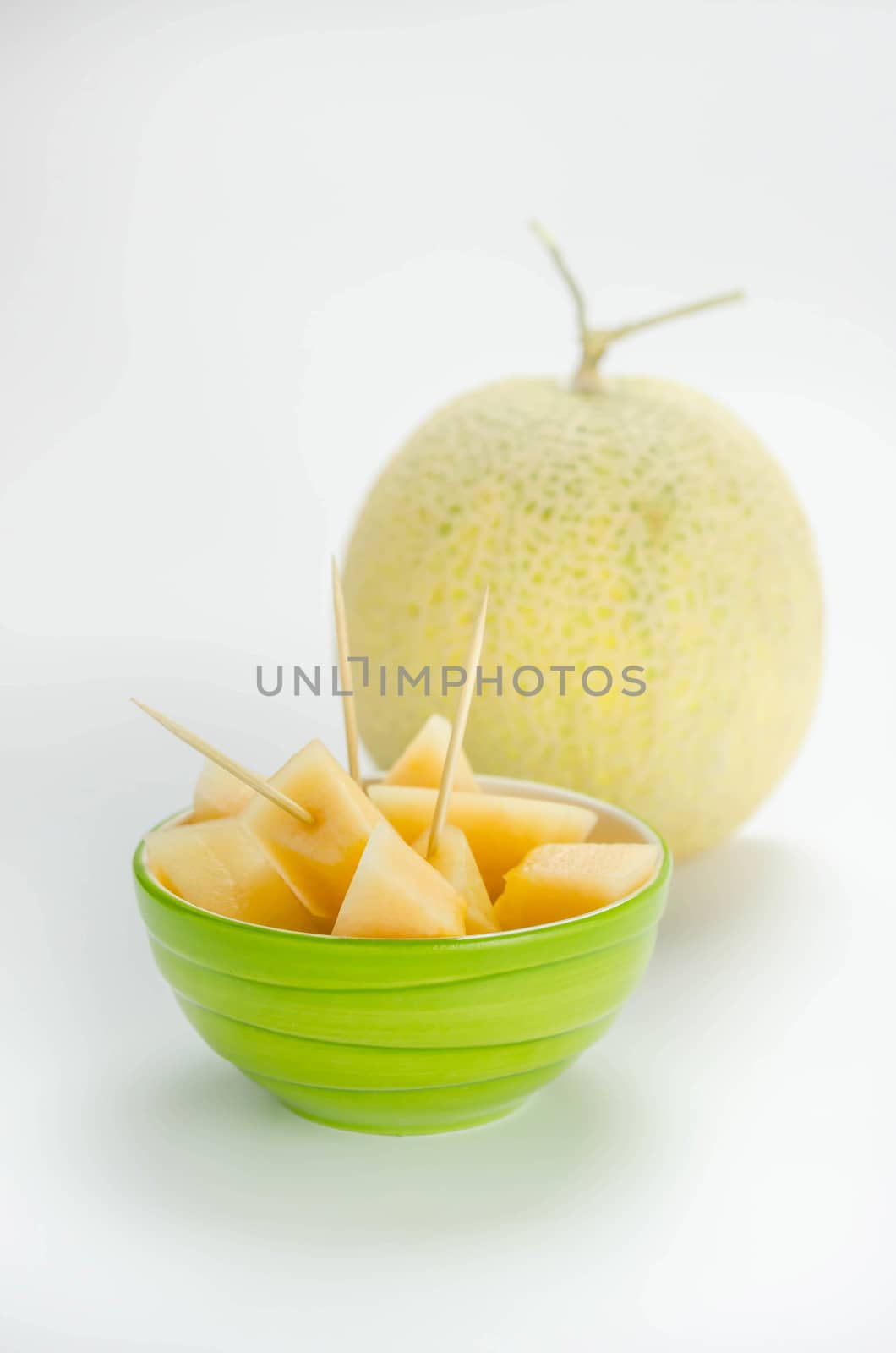 Ripe melon with slice on white background