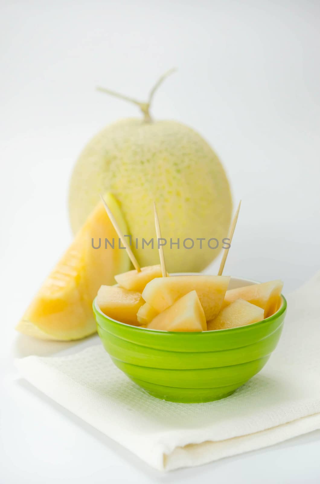 Ripe melon with slice on white background
