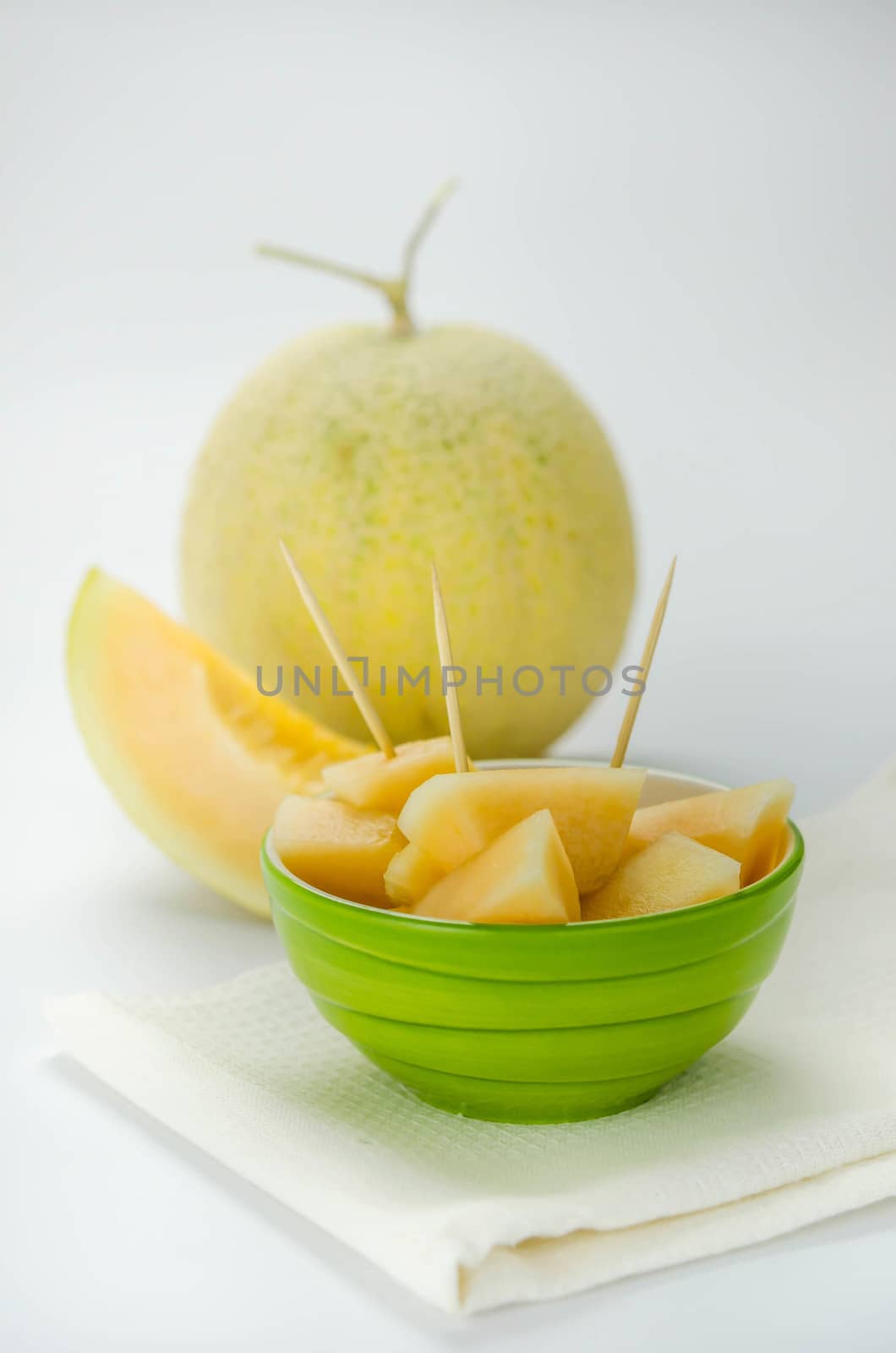 Ripe melon with slice on white background