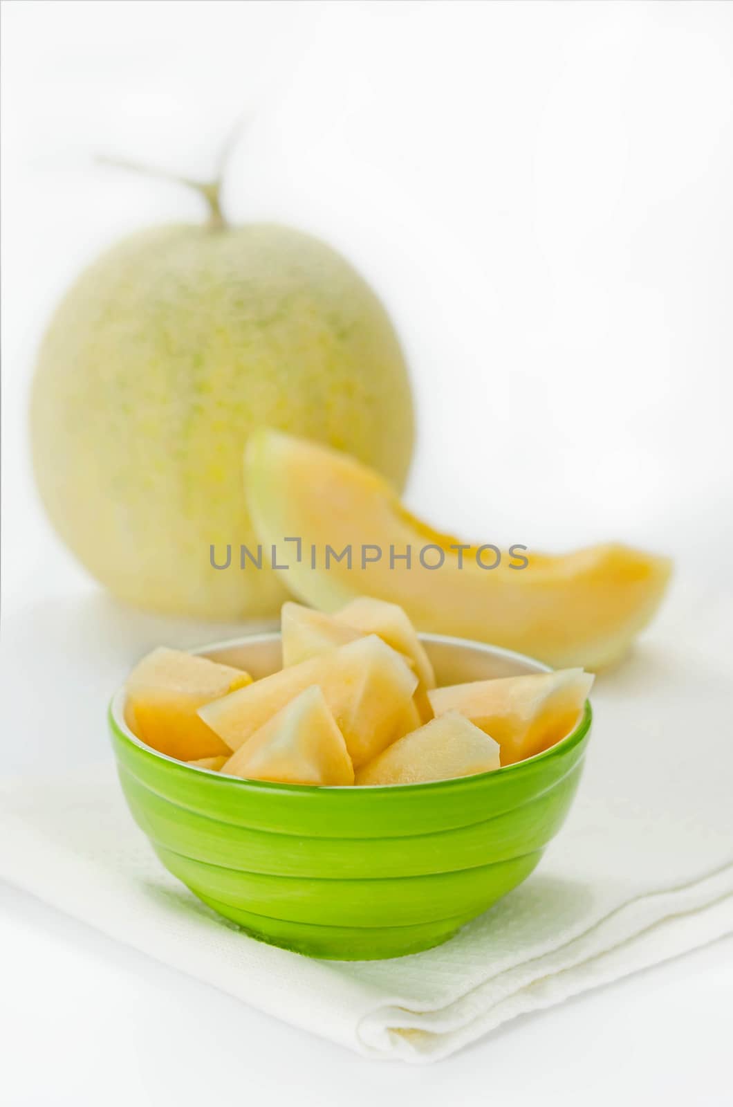 Ripe melon with slice on white background