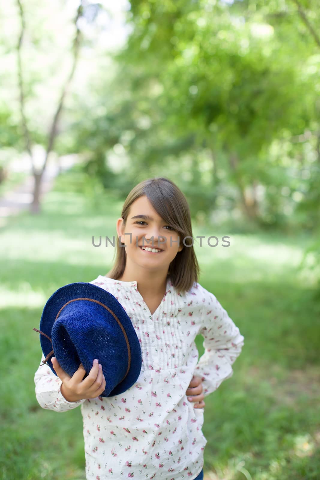 Girl smiling and posing at camera in a sunny summer day