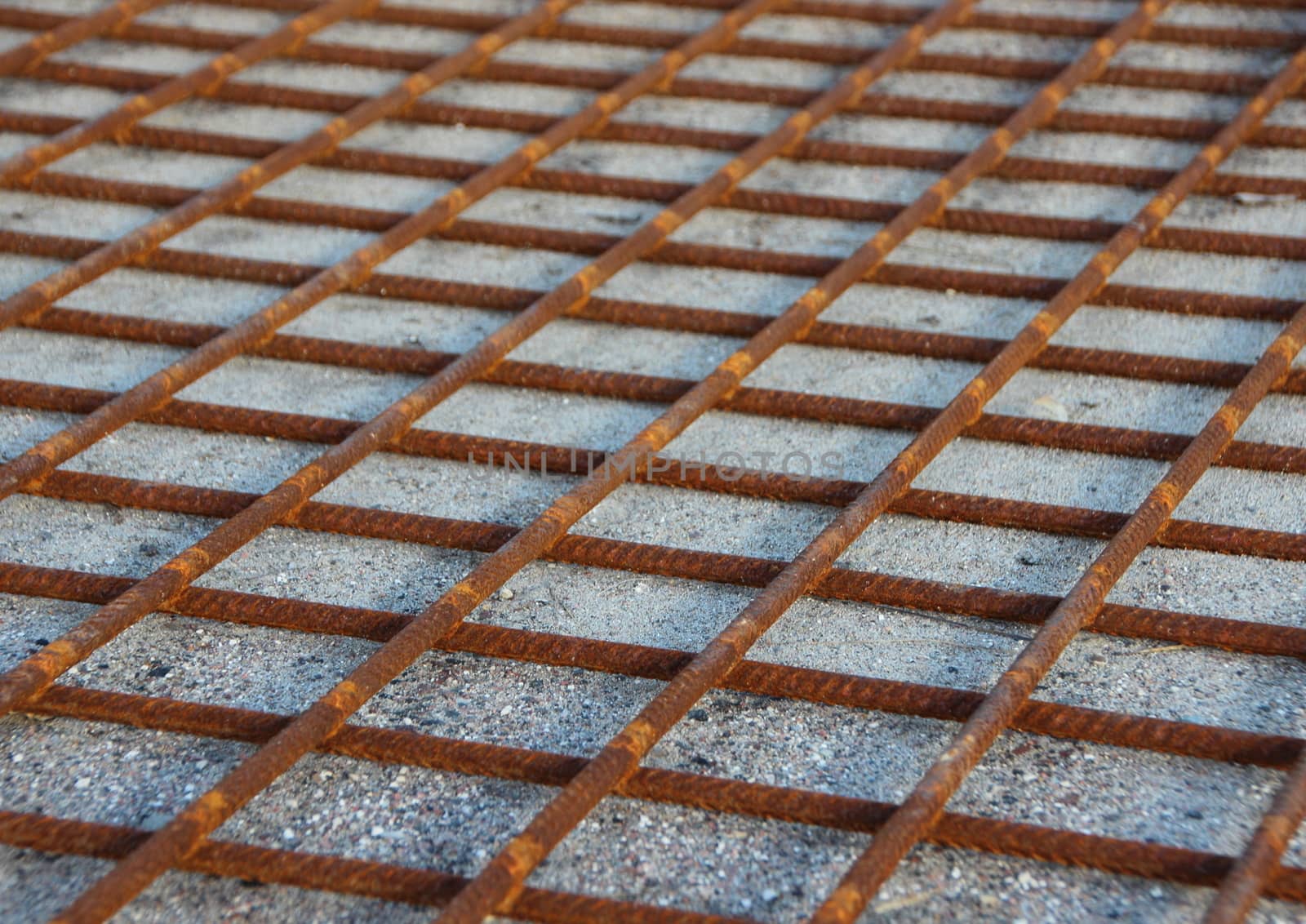 Rusty Metal Foundation Construction Grid on Sand Background
