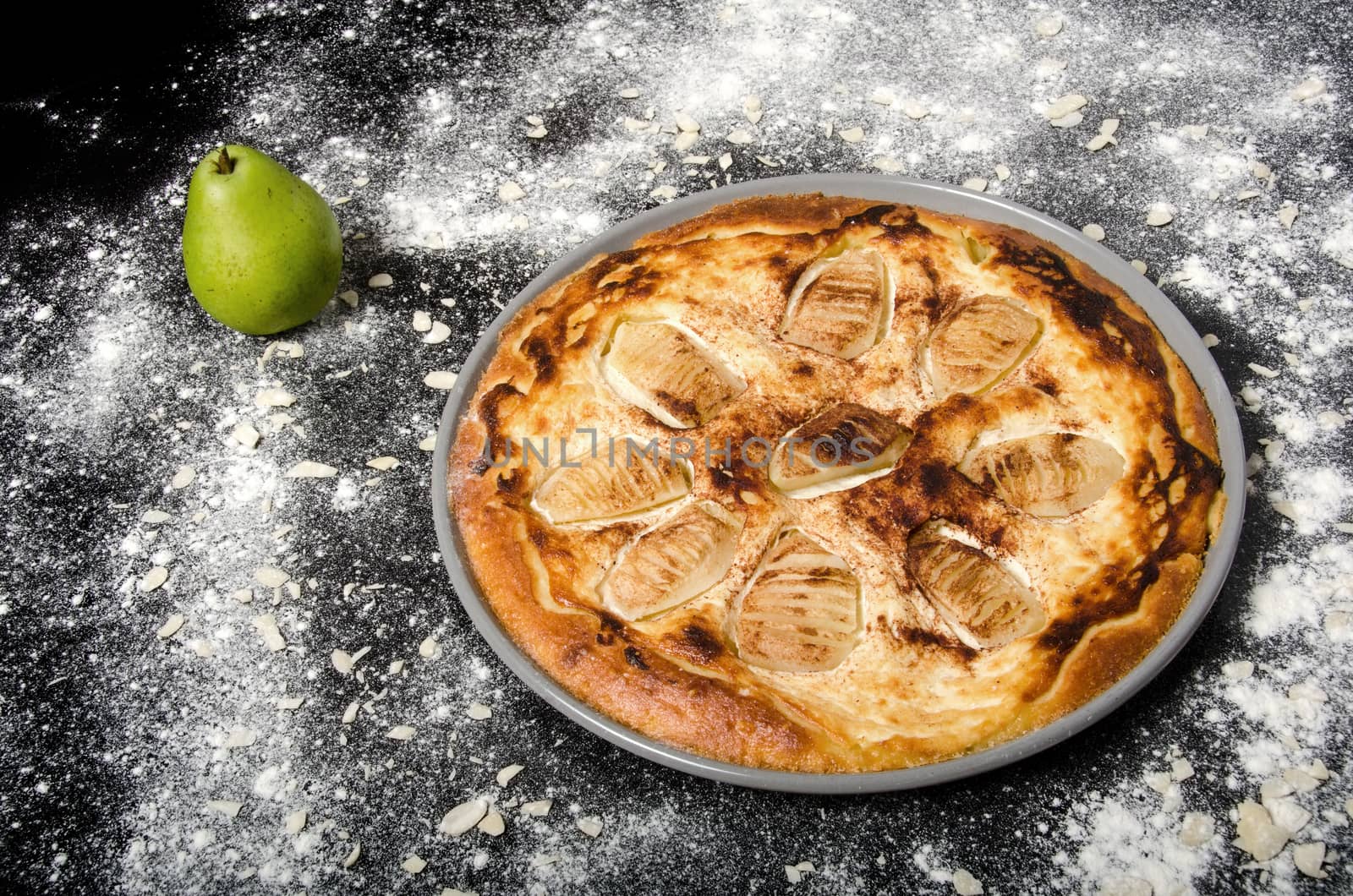 Sweet tasty pie with green pear and almonds.