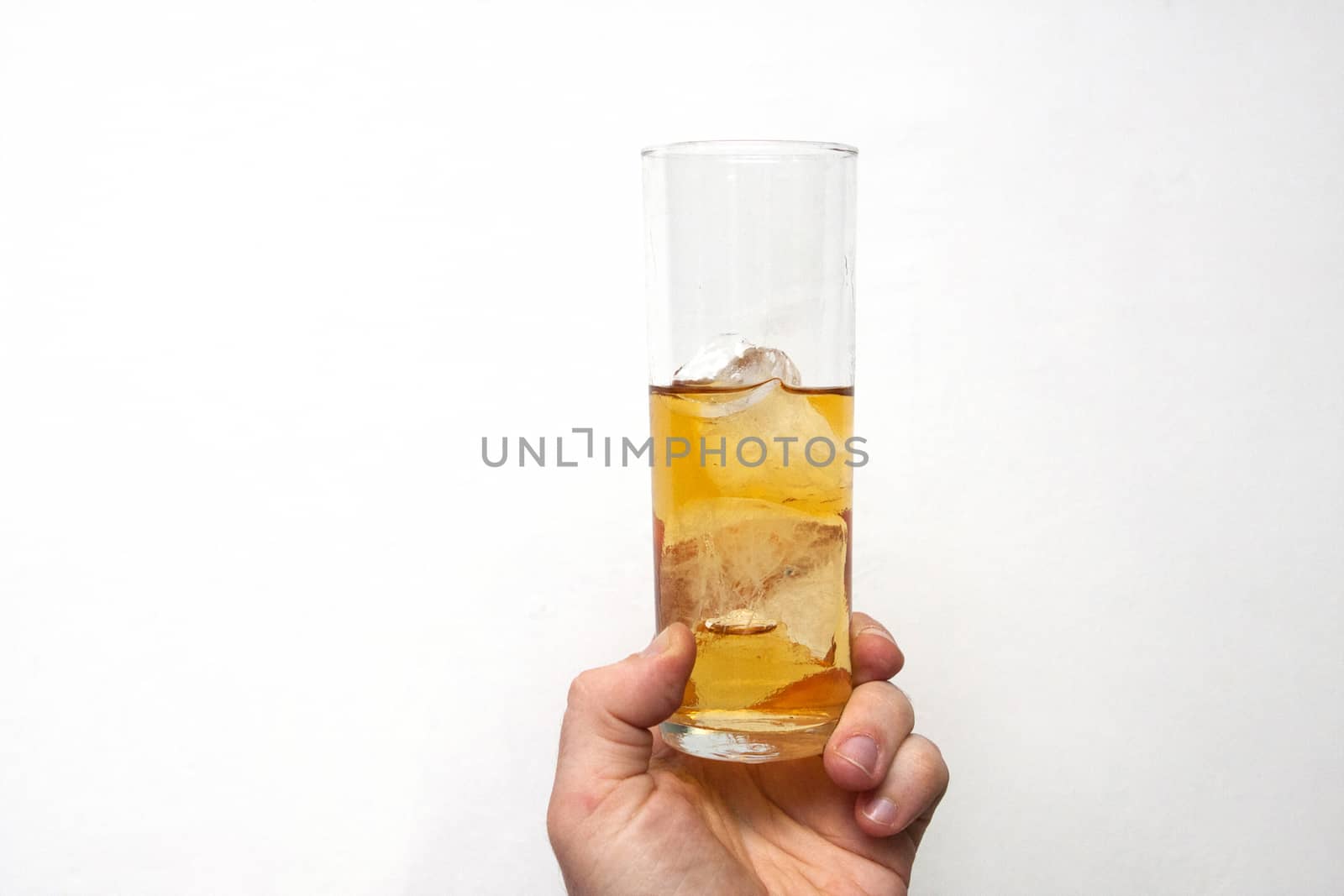 man holding glass of alcoholic drink