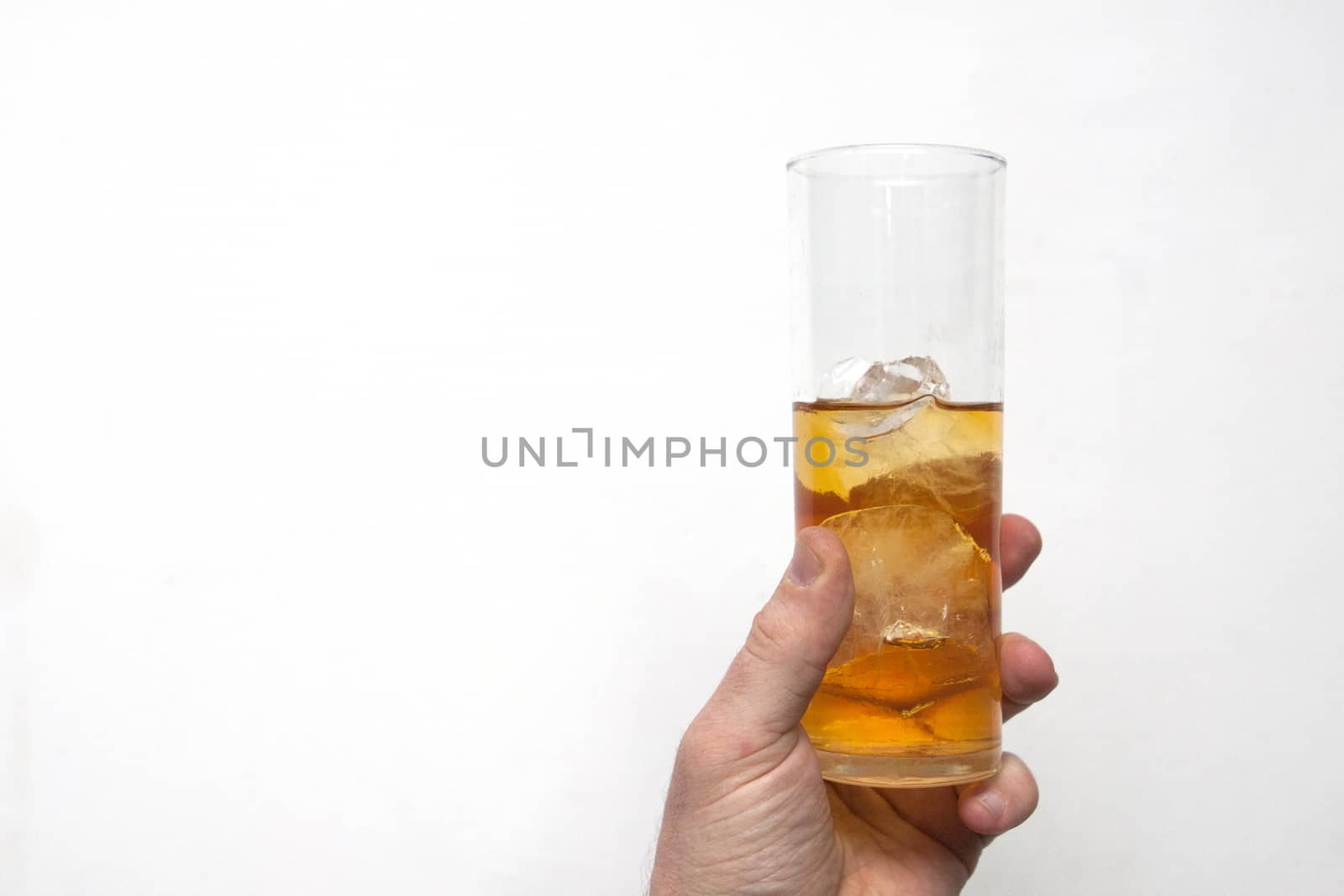 man holding glass of alcoholic drink