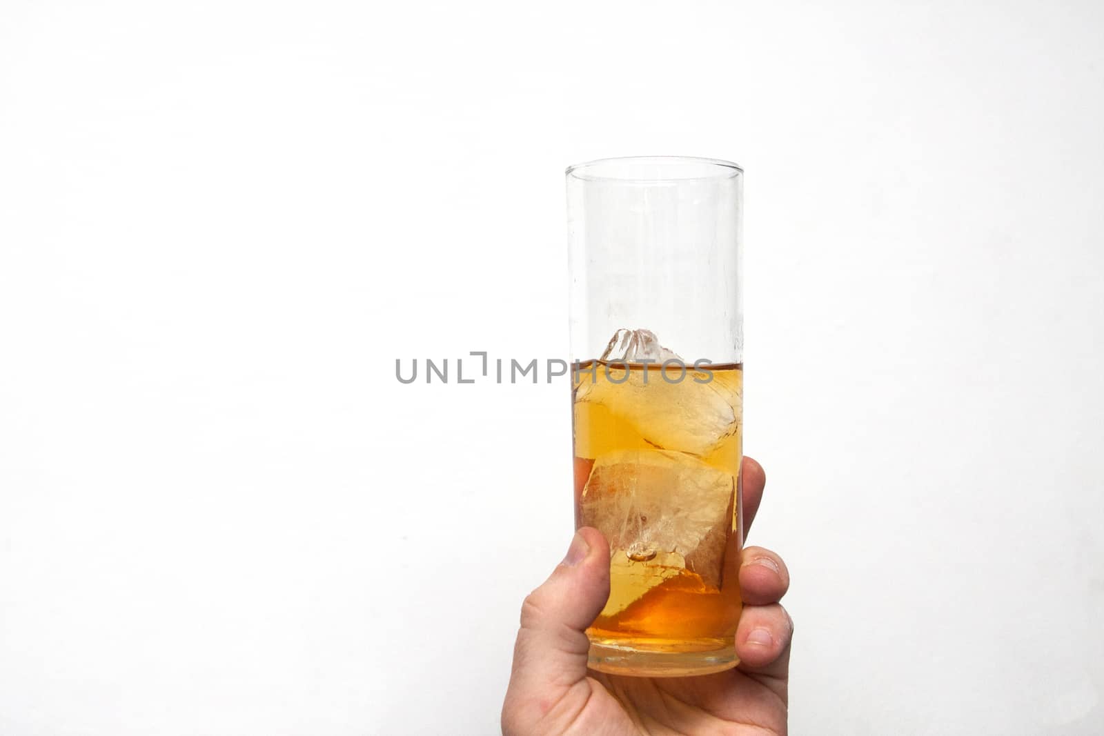 man holding glass of alcoholic drink