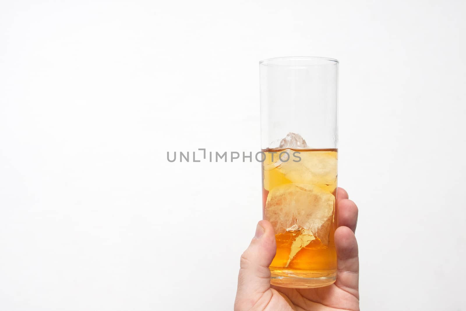 man holding glass of alcoholic drink