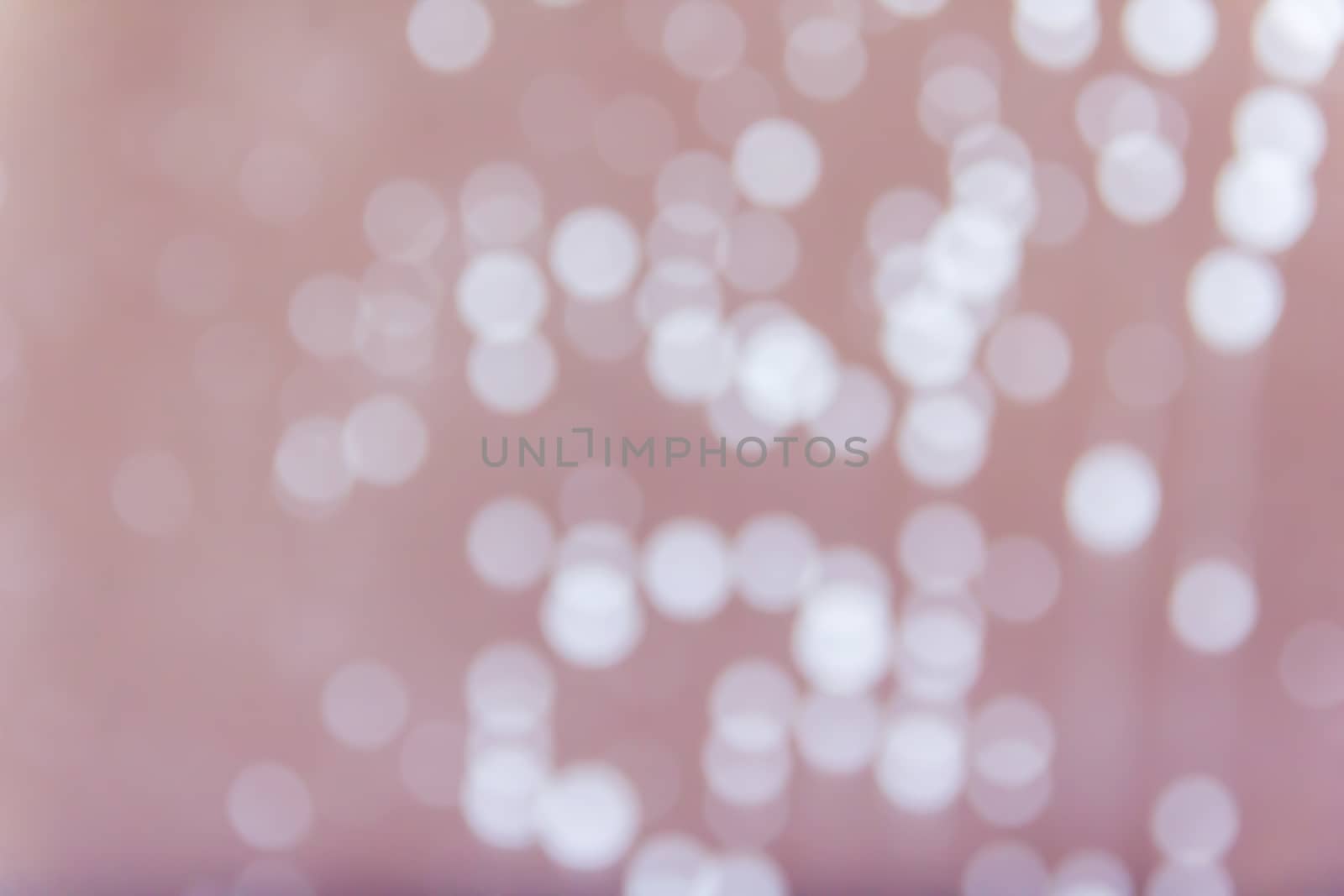 Abstract blurred background with rain or water drop bokeh on glass mirror in sweet pastel pink colour 