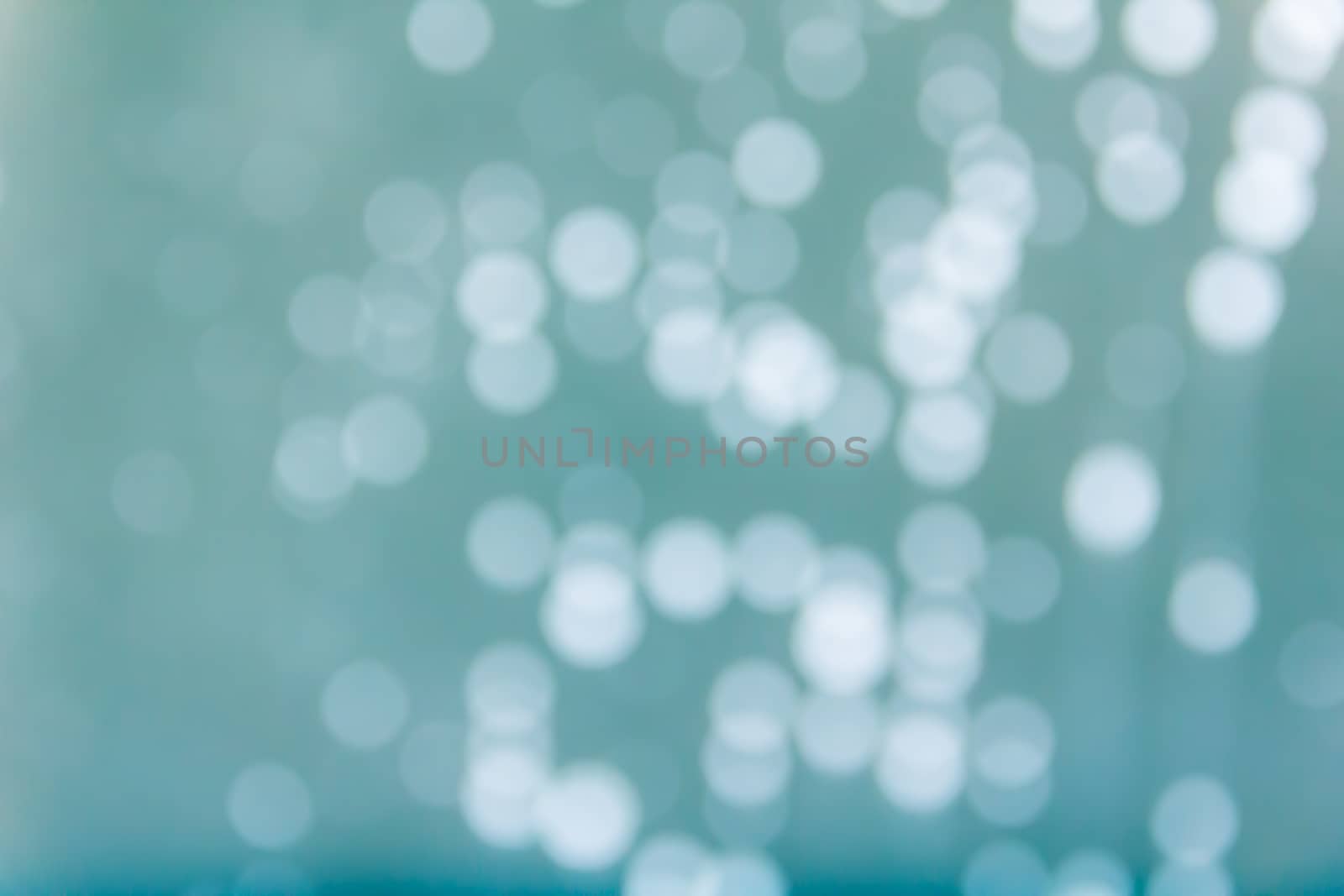 Romantic pastel bokeh water drop on glass mirror plate abstract aqua green background