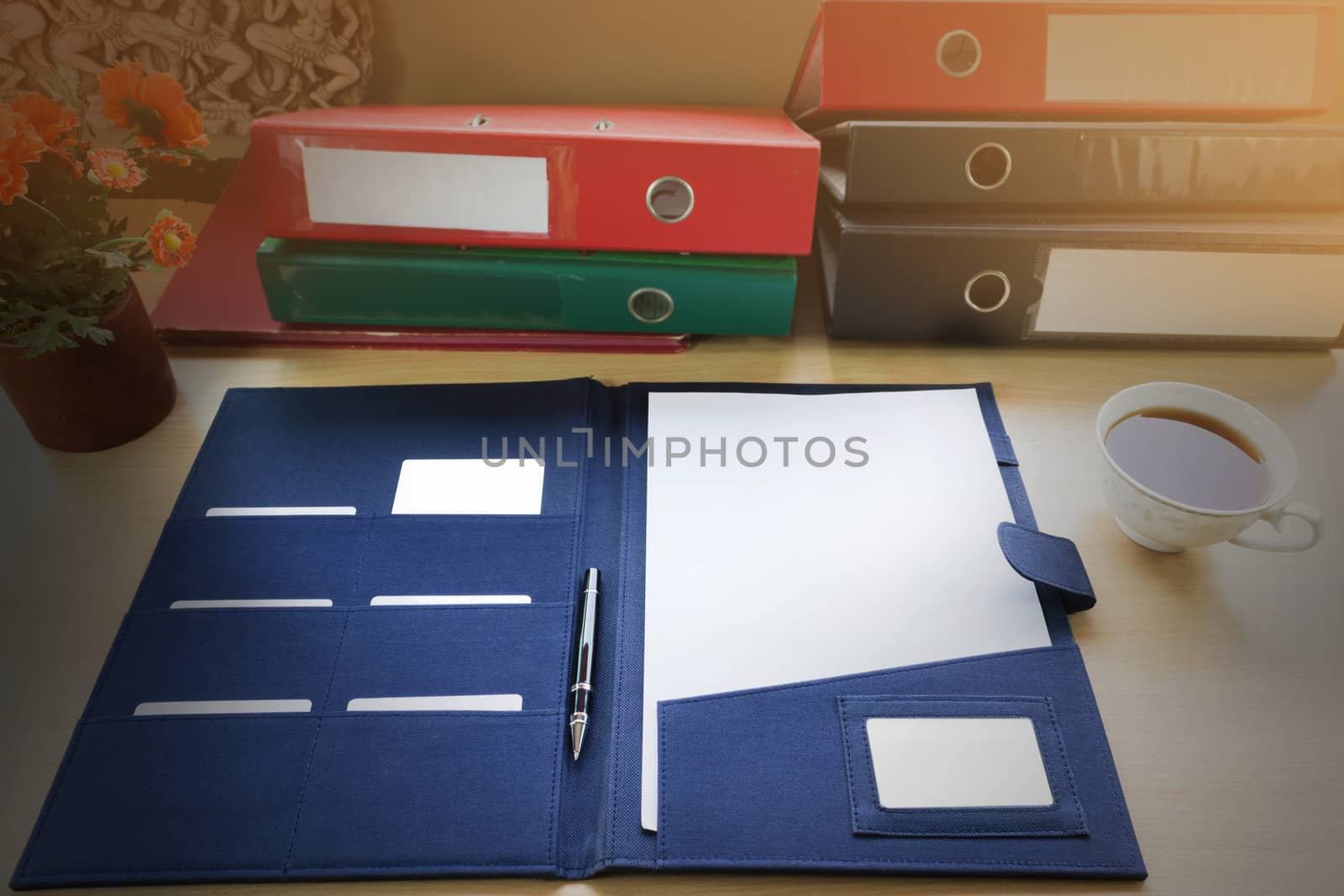 Blank paper note with pen on document file on work table 