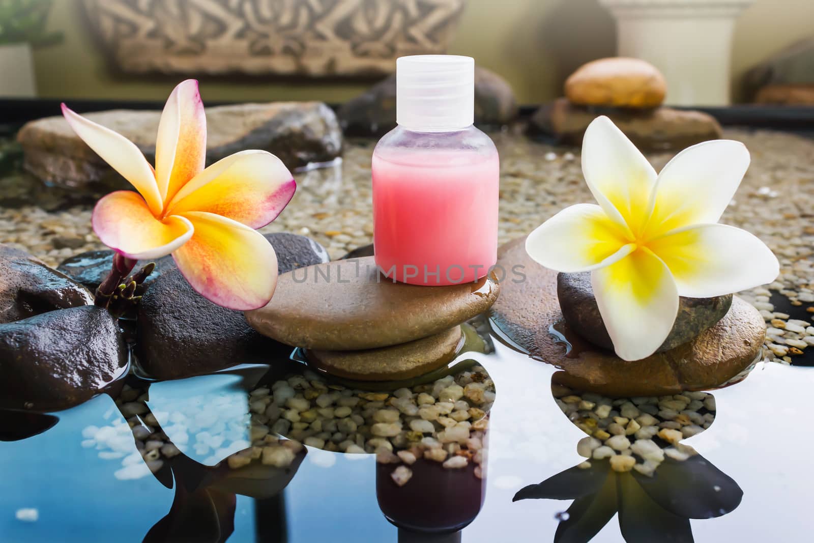 Mini set of bubble bath and shower gel decorated in zen style with pebble rock and flower with relaxing mood
