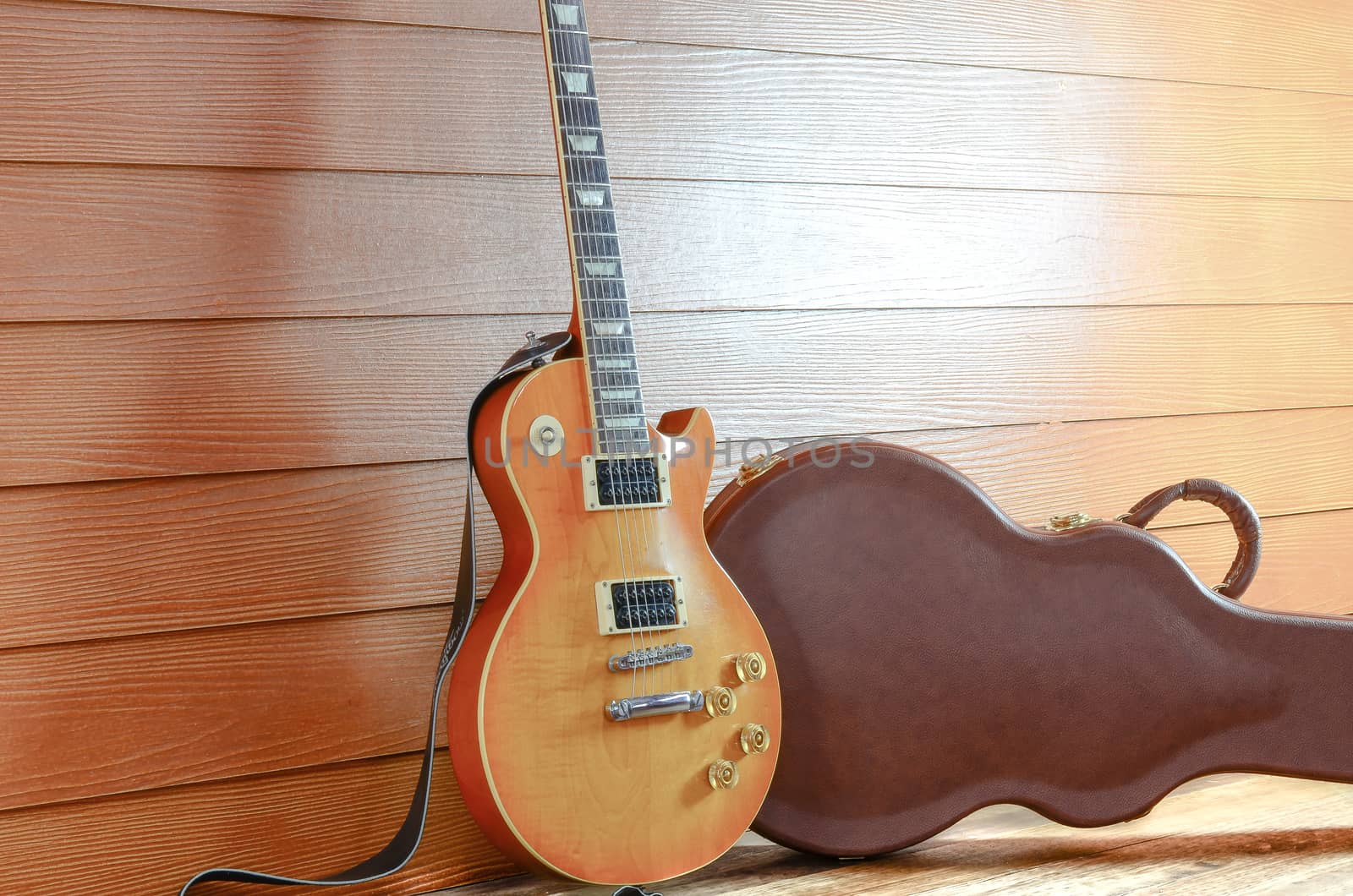 Electric Guitar and case in wood room