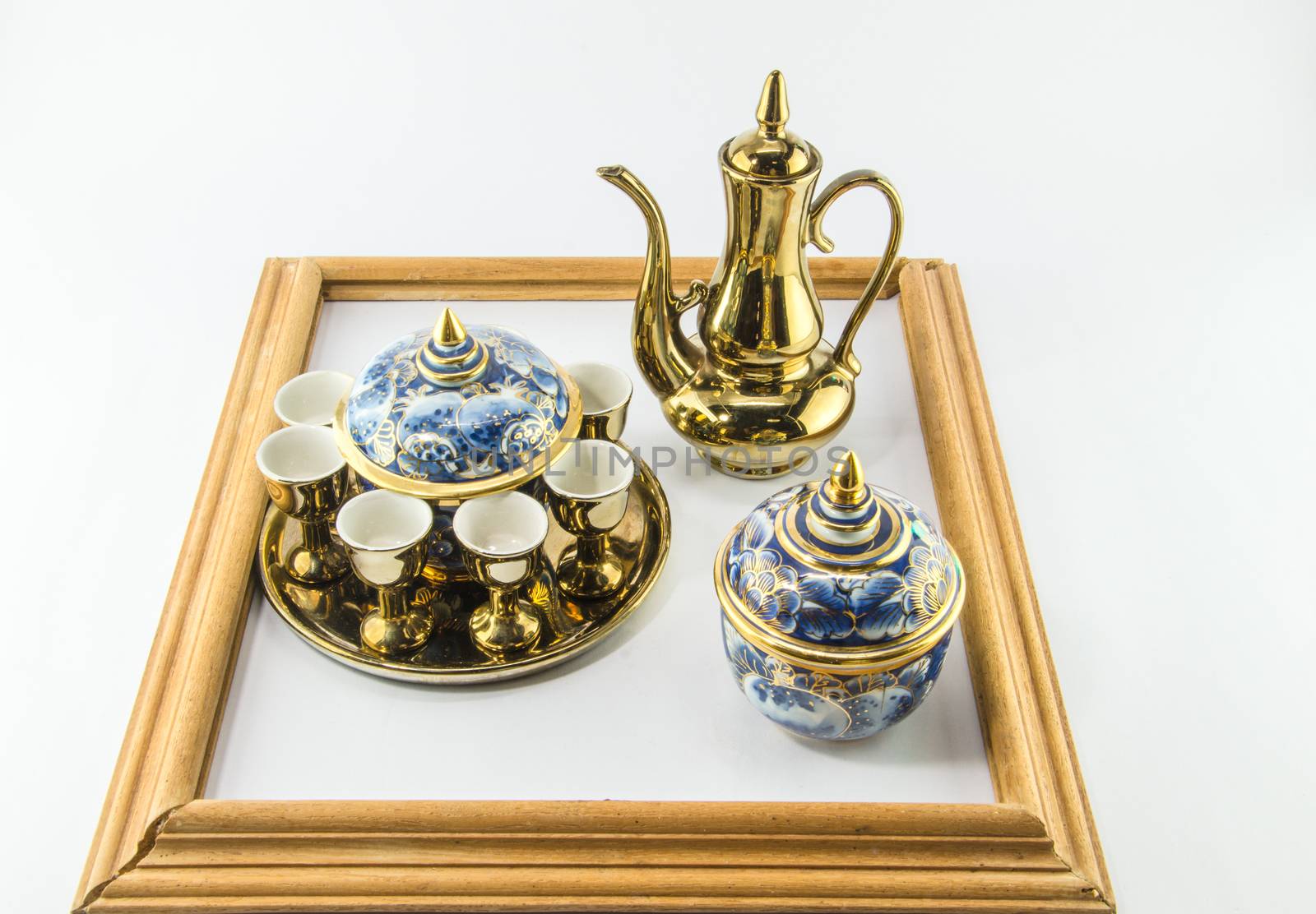 Gold jug Tea glass benjarong in frame on white background by metal22