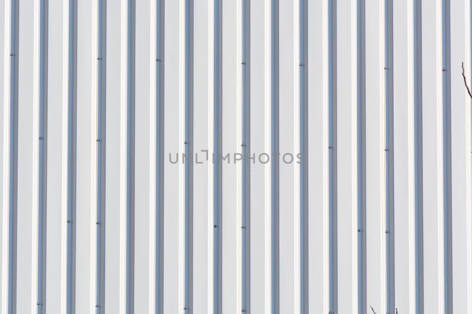 Silver-colored metal wall corrugated sheet metal background.