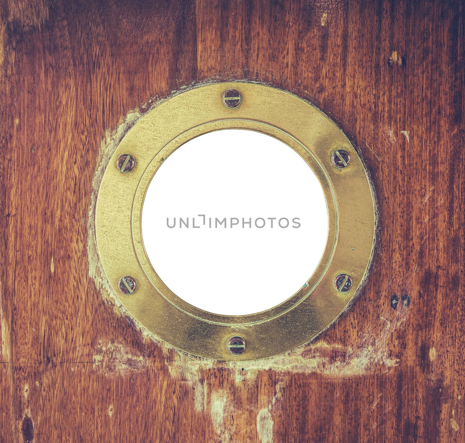A Vintage Brass Or Bronze Porthole In A Ship's Door With Isolated Center