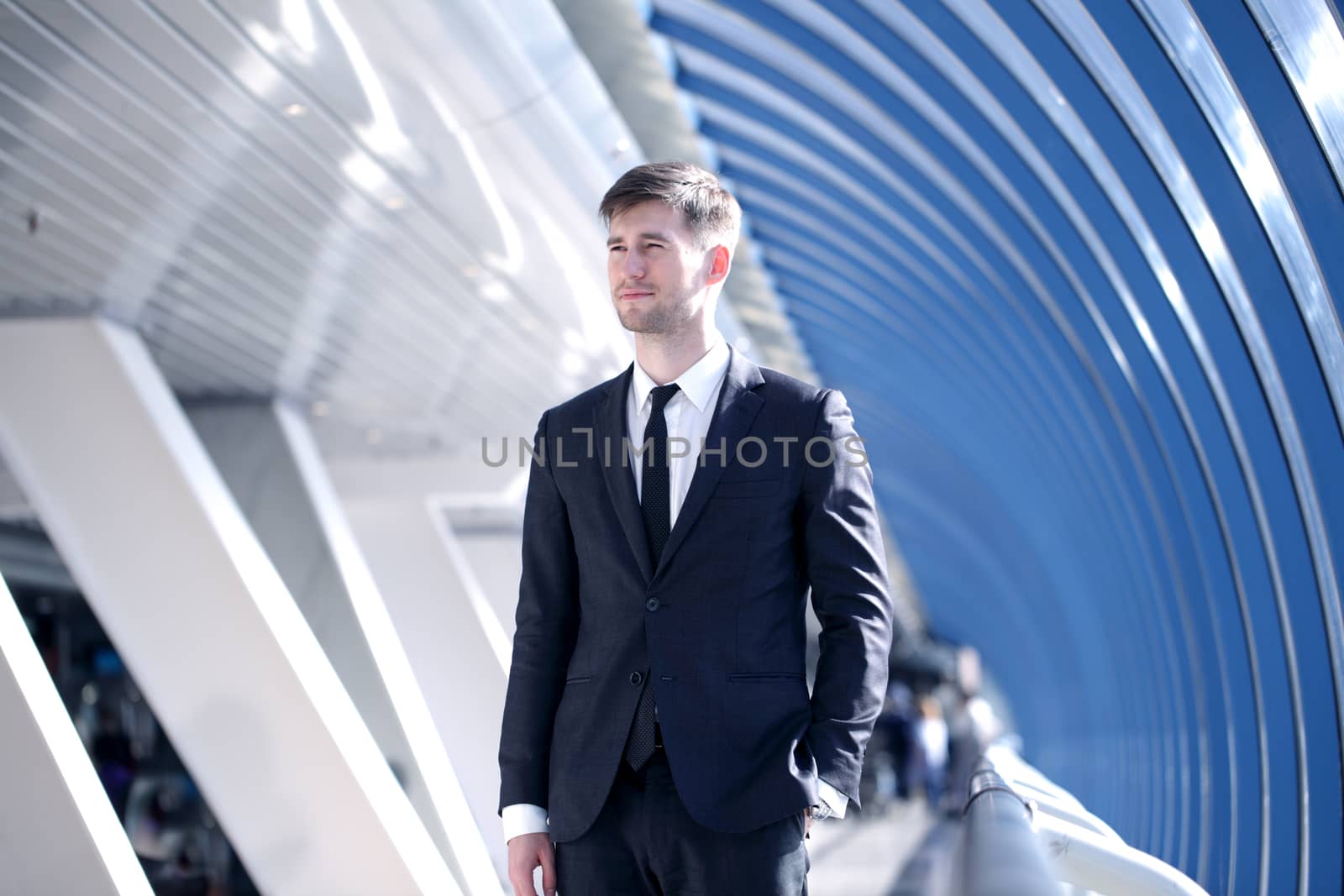 Young Businessman standing in corridor of modern office building