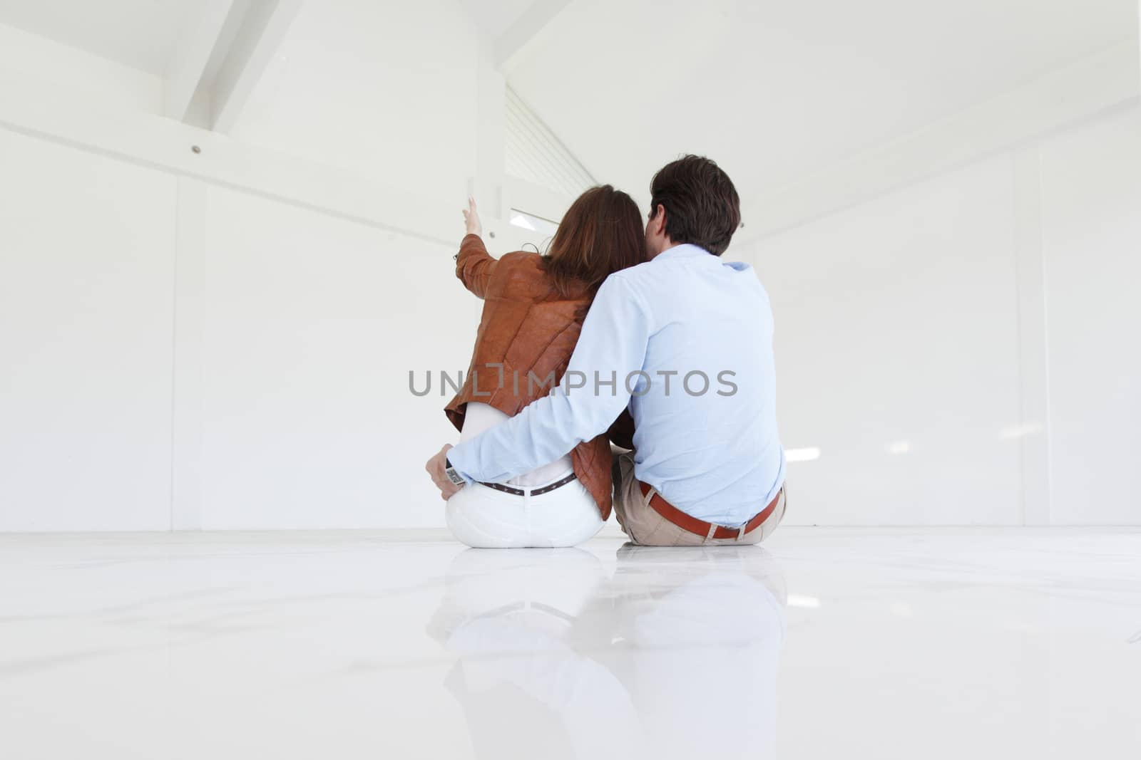 Couple sitting at their new empty apartment