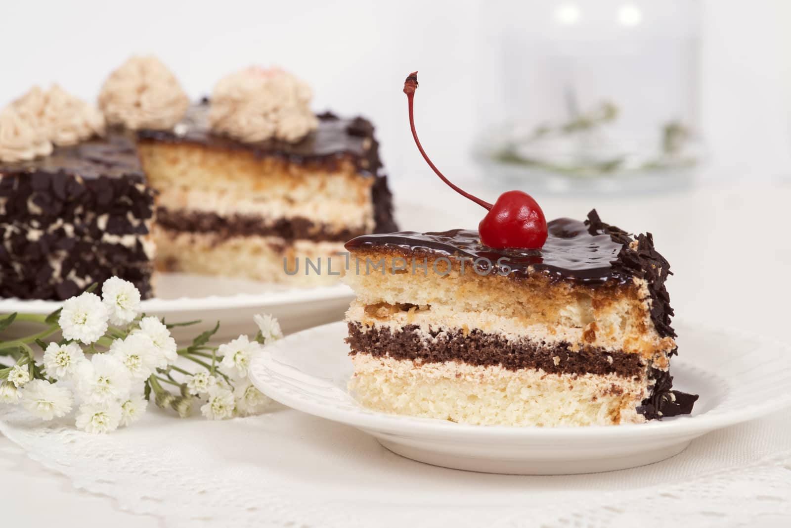 Cake on plate on table on light background