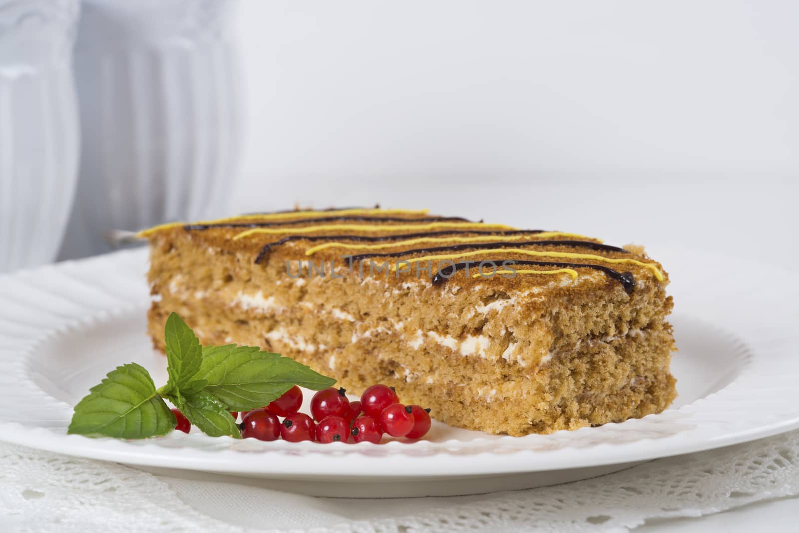 Honey cake on the plate on light background