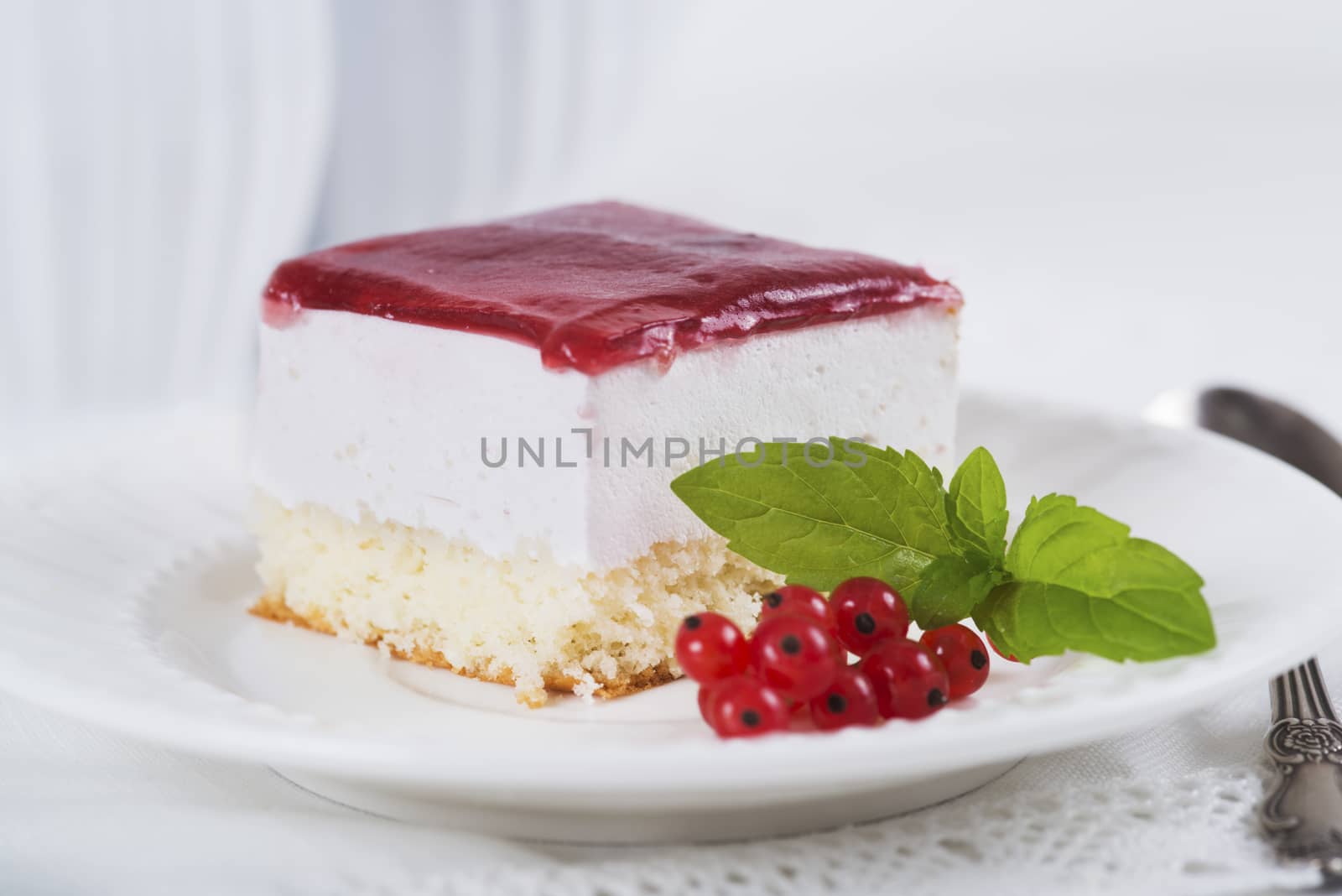 Milk souffle (bird's milk) cake with fresh currant on light background