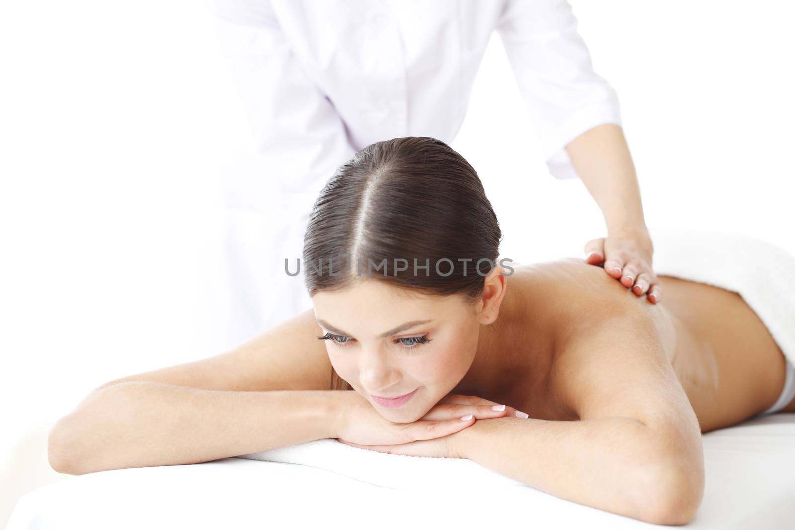 Beautiful young woman getting massage, isolated on white background