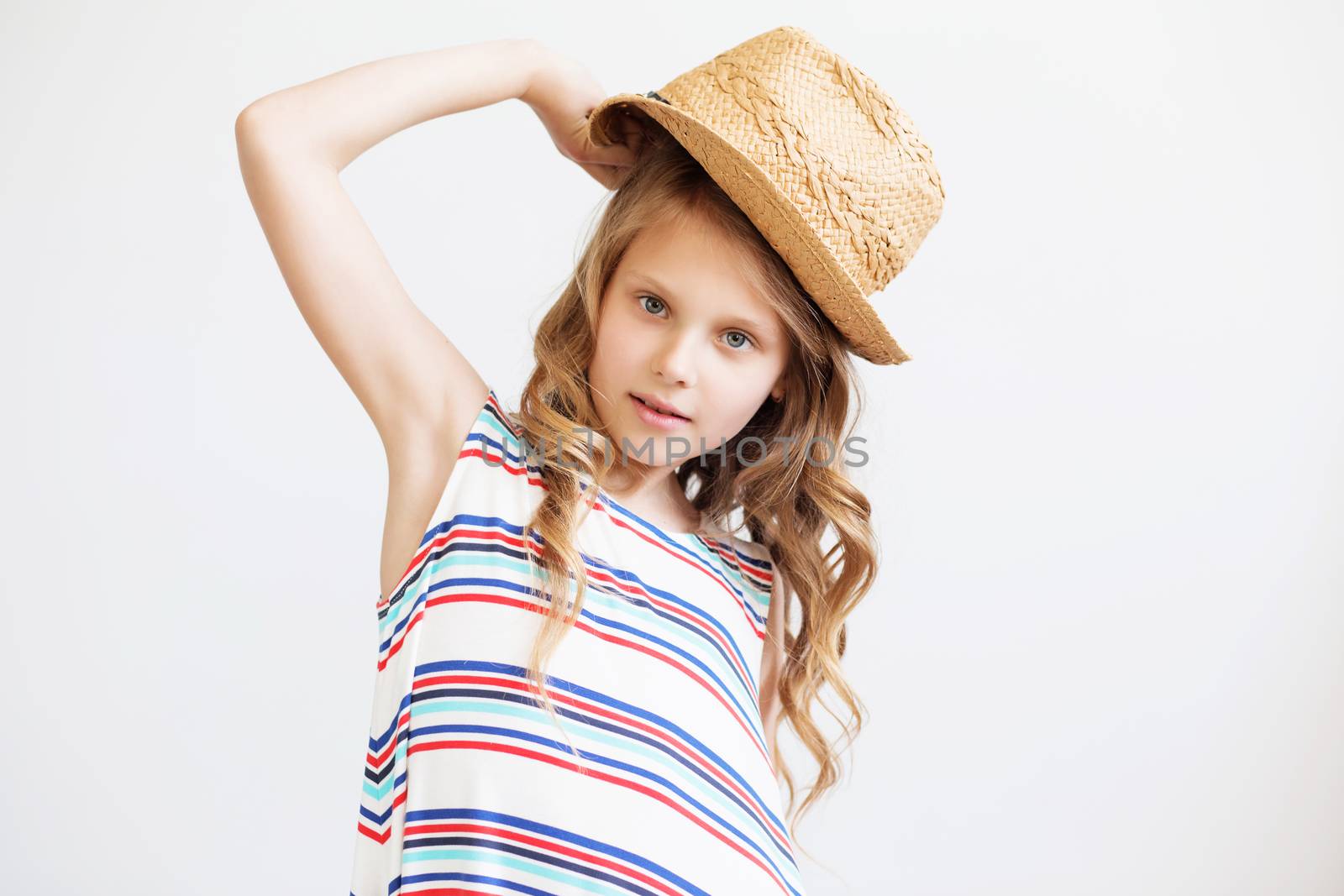 lovely little girl with straw hat against a white background