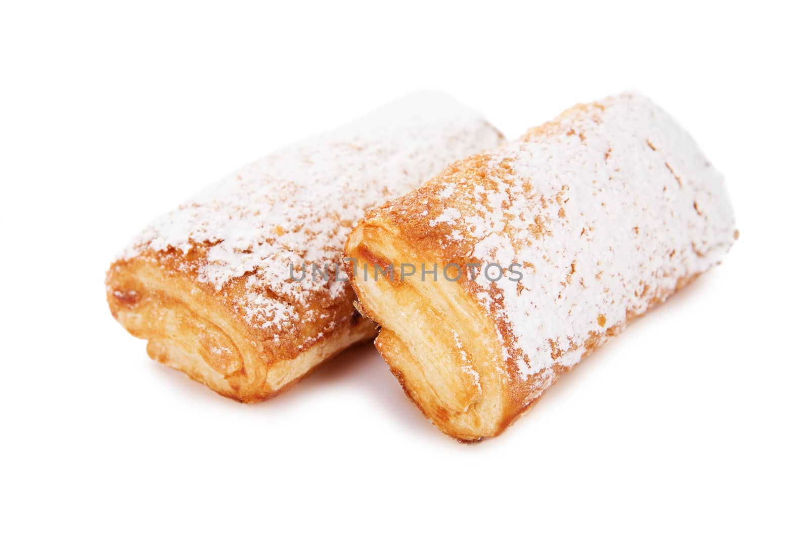Cookies of puff pastry topped with powdered sugar isolated on white background