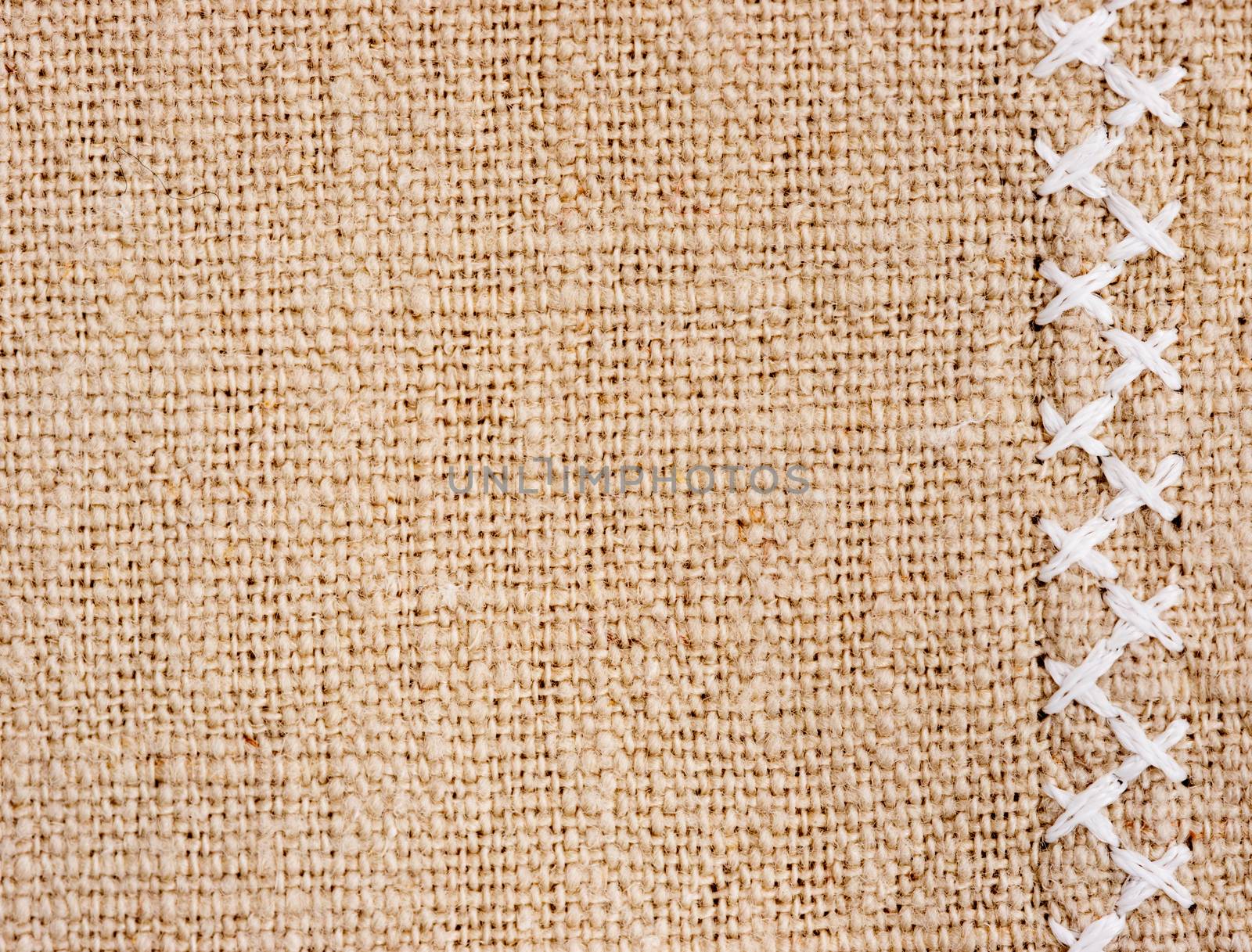 Natural cotton fabric with cross stitch close up as background texture