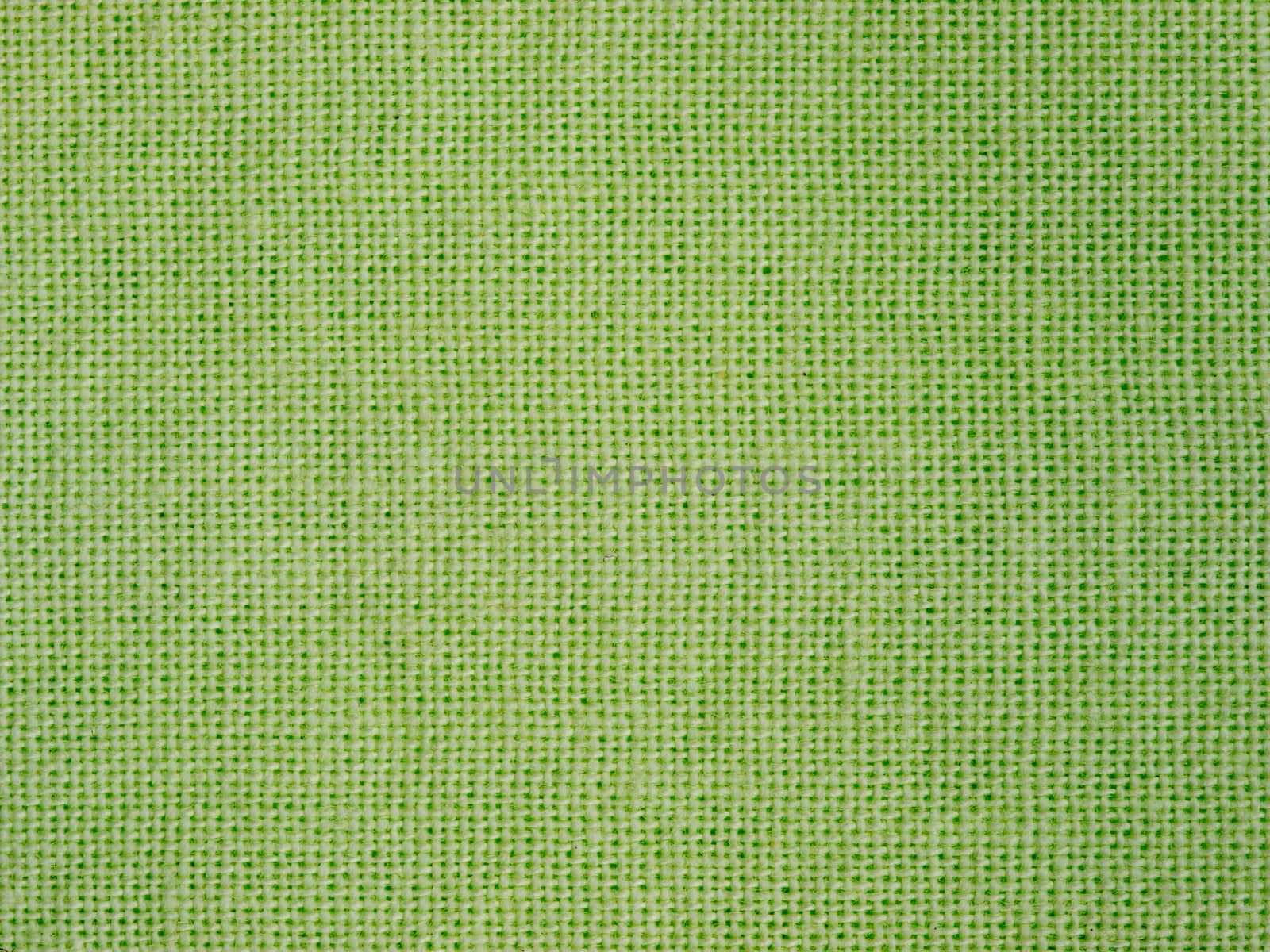 Natural green cotton fabric weaving close up as background texture