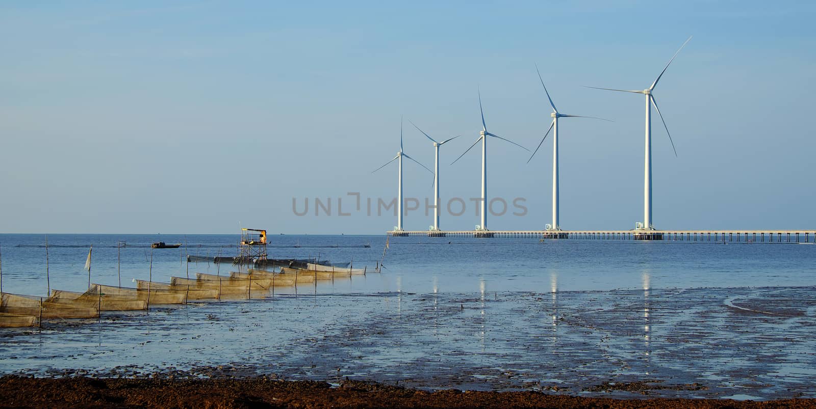 Group of wind turbines of Bac Lieu wind power plant at Mekong Delta, Vietnam. Windmill at Baclieu seaside at morning, make clean energy for Viet nam industry