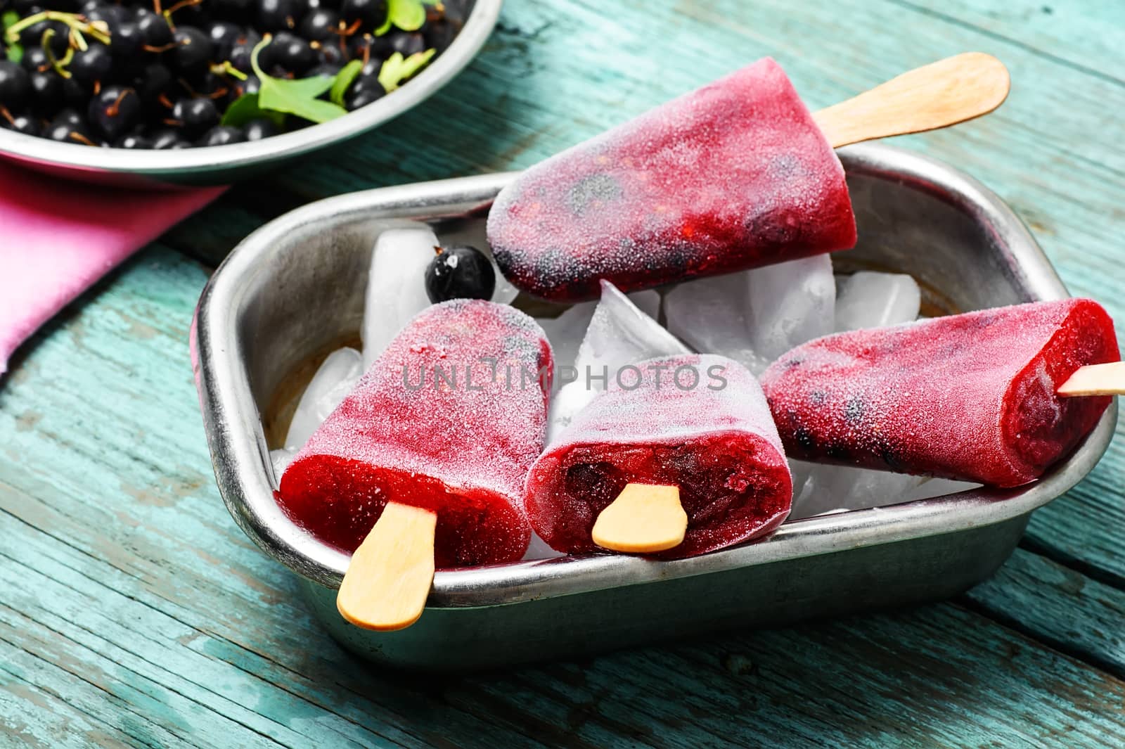 Ice-cream and summer berries in metal tray with ice