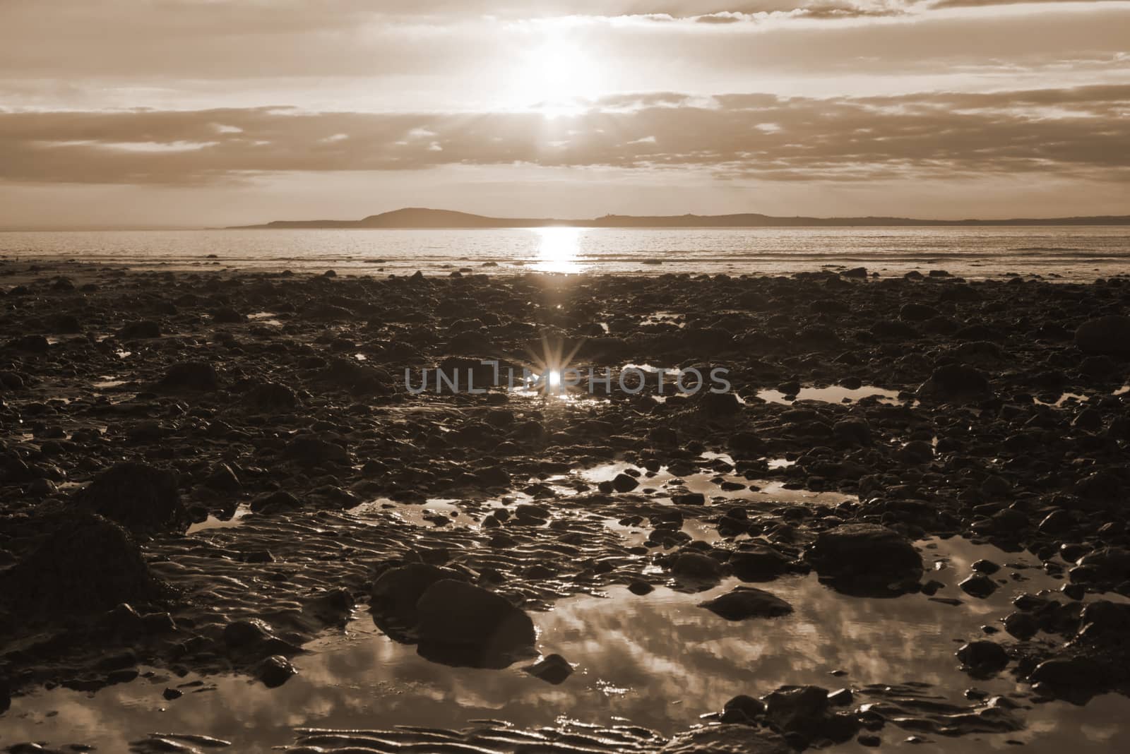 reflections at rocky beal beach near ballybunion on the wild atlantic way ireland with a beautiful yellow sunset