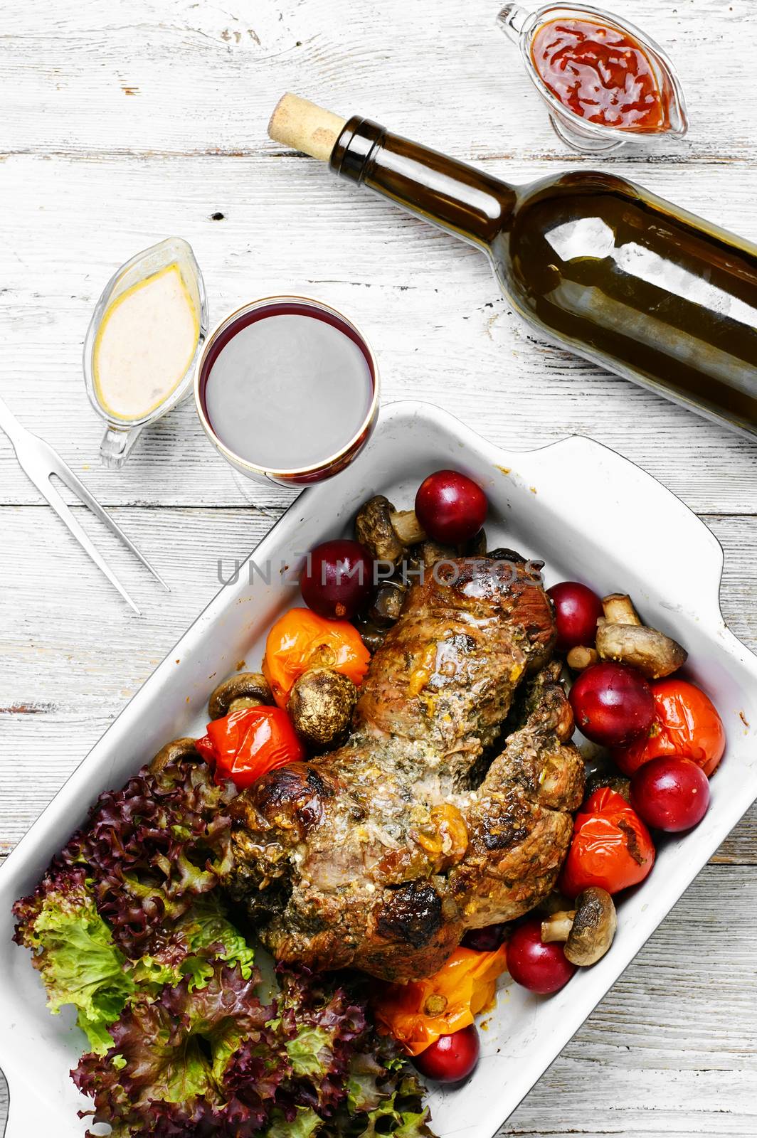 Form baked meat loaf of veal with plum sauce,seasoning and wine