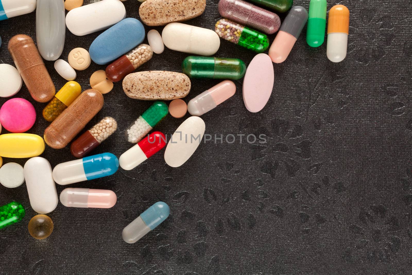 Colorful pills over dark background