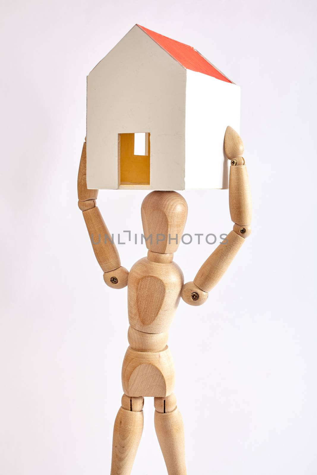 Dummy carrying small house on white background