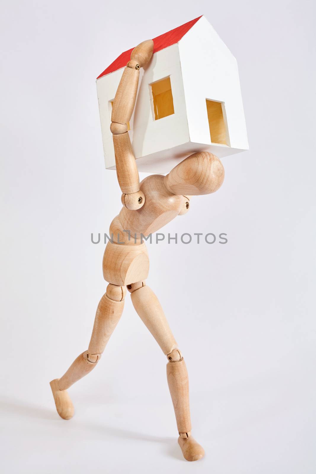 Dummy carrying small house on white background