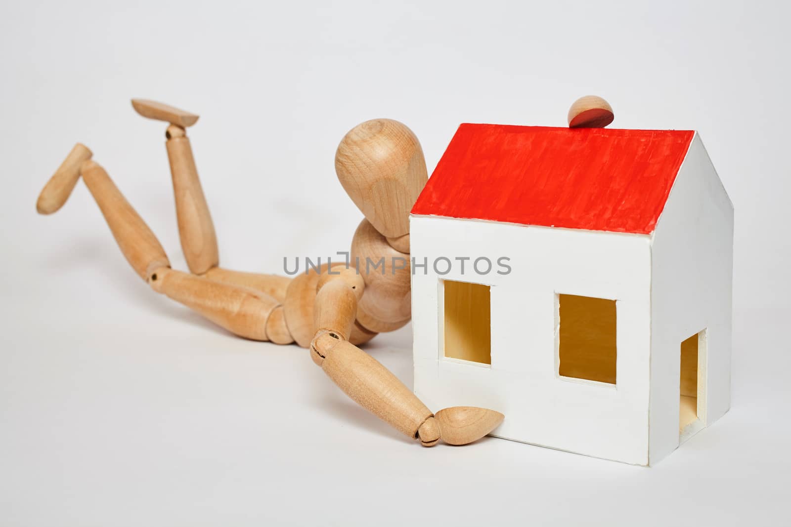 Dummy feeling happy with small house on white background