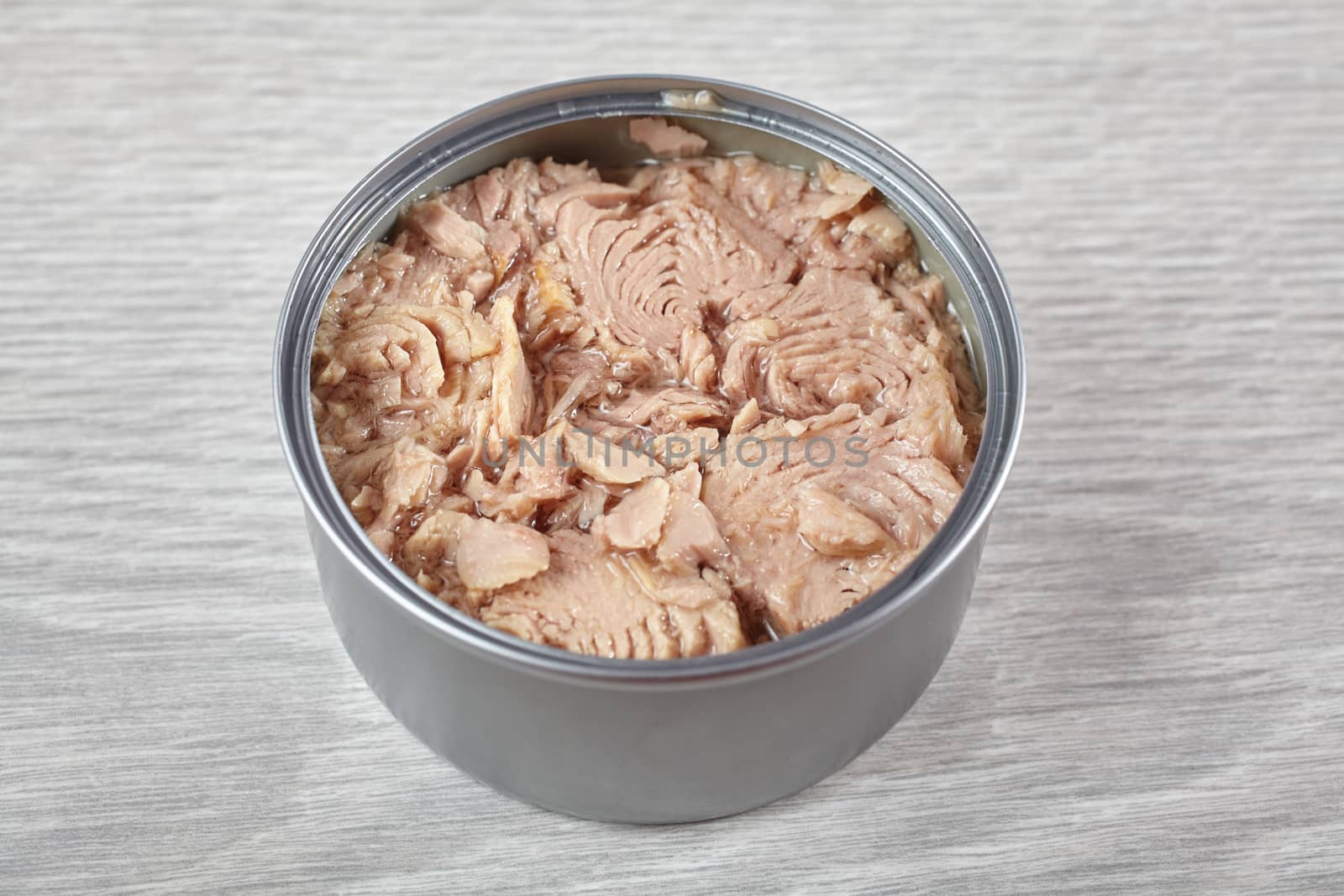 Open tuna tin on a gray background