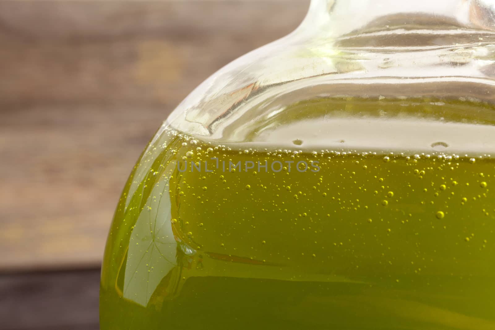 Olive oil bottle on wooden background