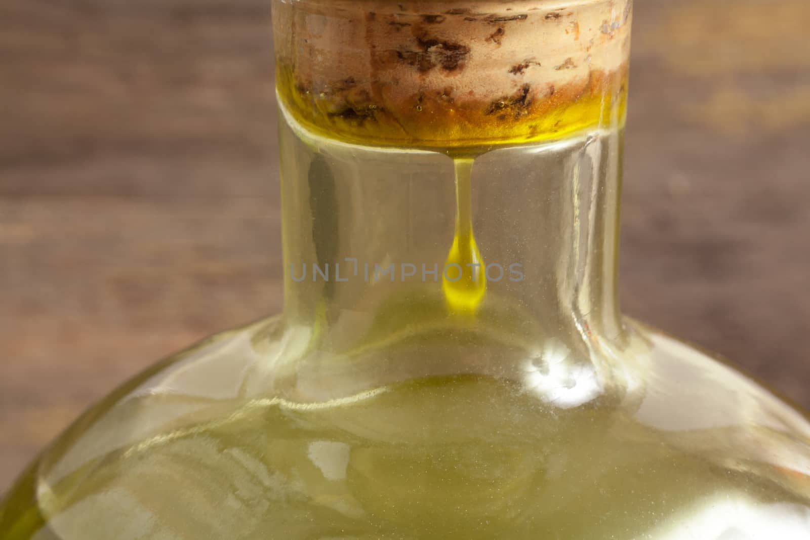 Olive oil bottle on wooden background