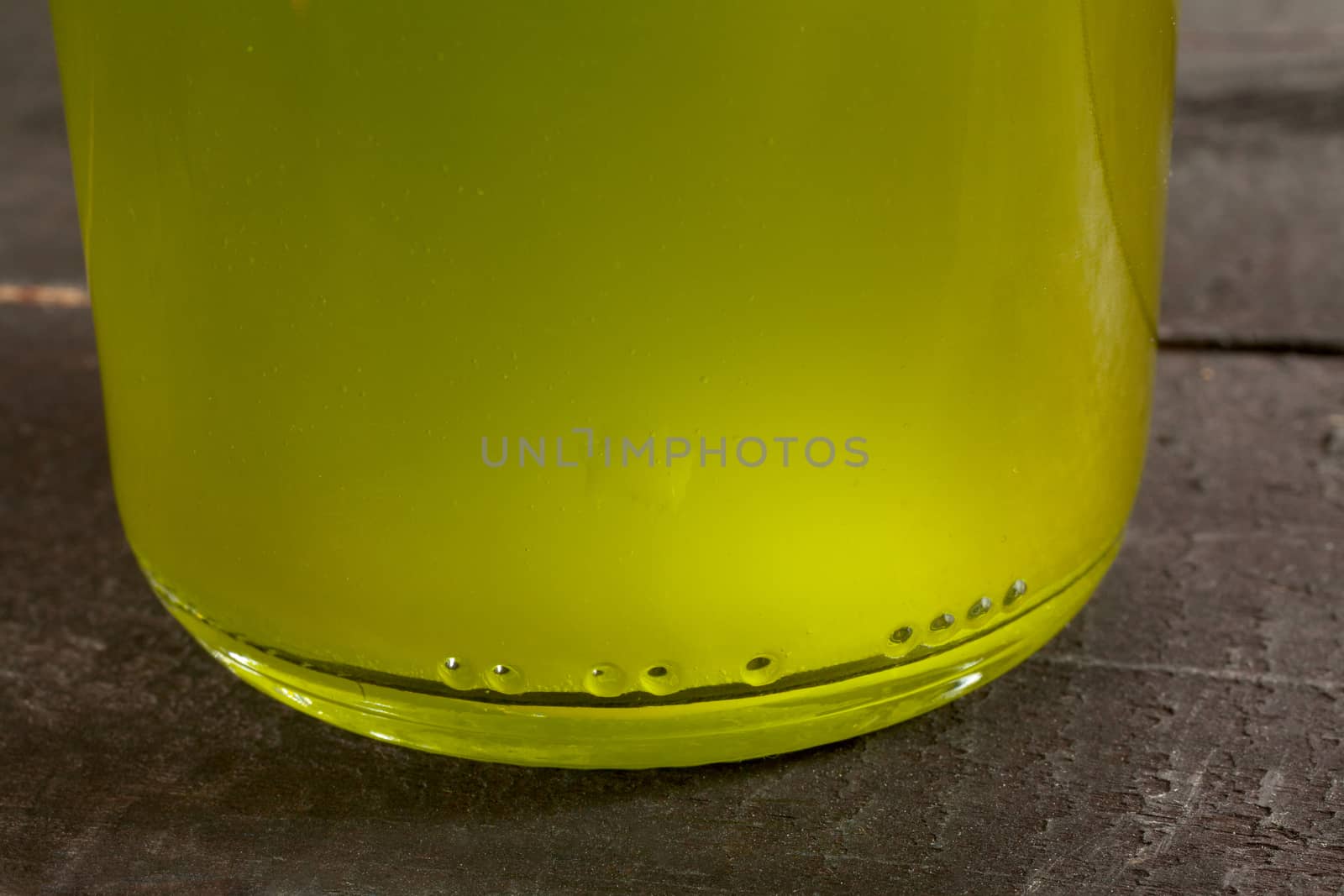 Olive oil bottle on wooden background
