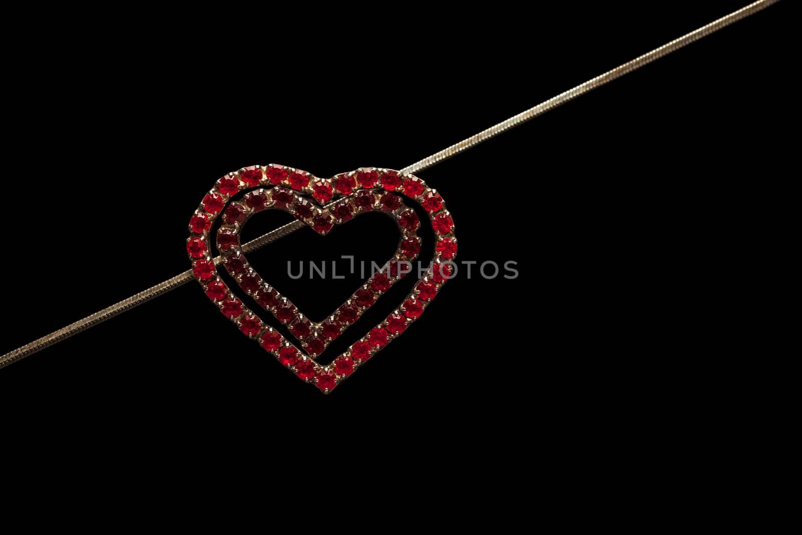 Heart-shaped necklace on black background