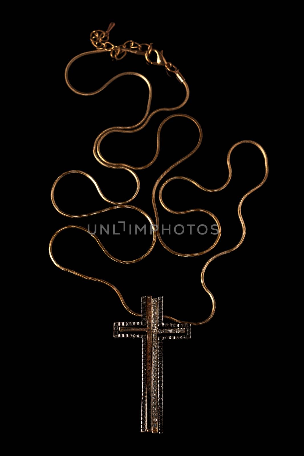 Golden chain necklace with cross on blackground