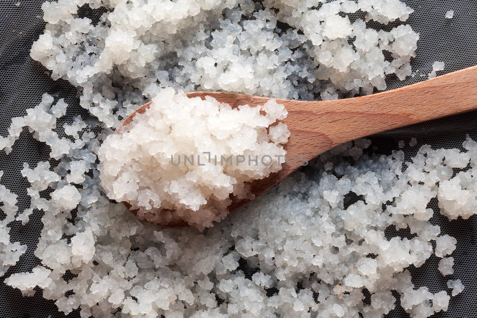 Water kefir over tulle with wooden spoon