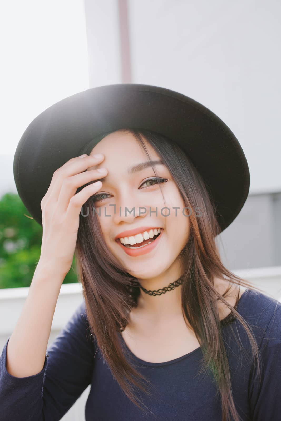 Beautiful asian young woman smiling on the city .
