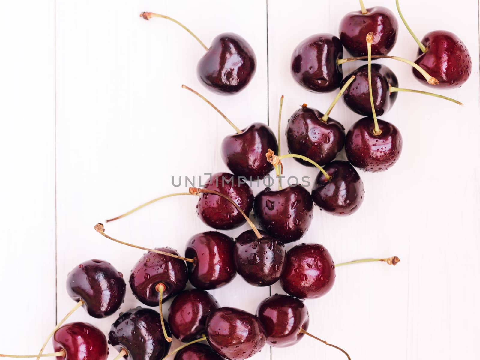 Ripe cherry on white wooden table. Top view or flat lay