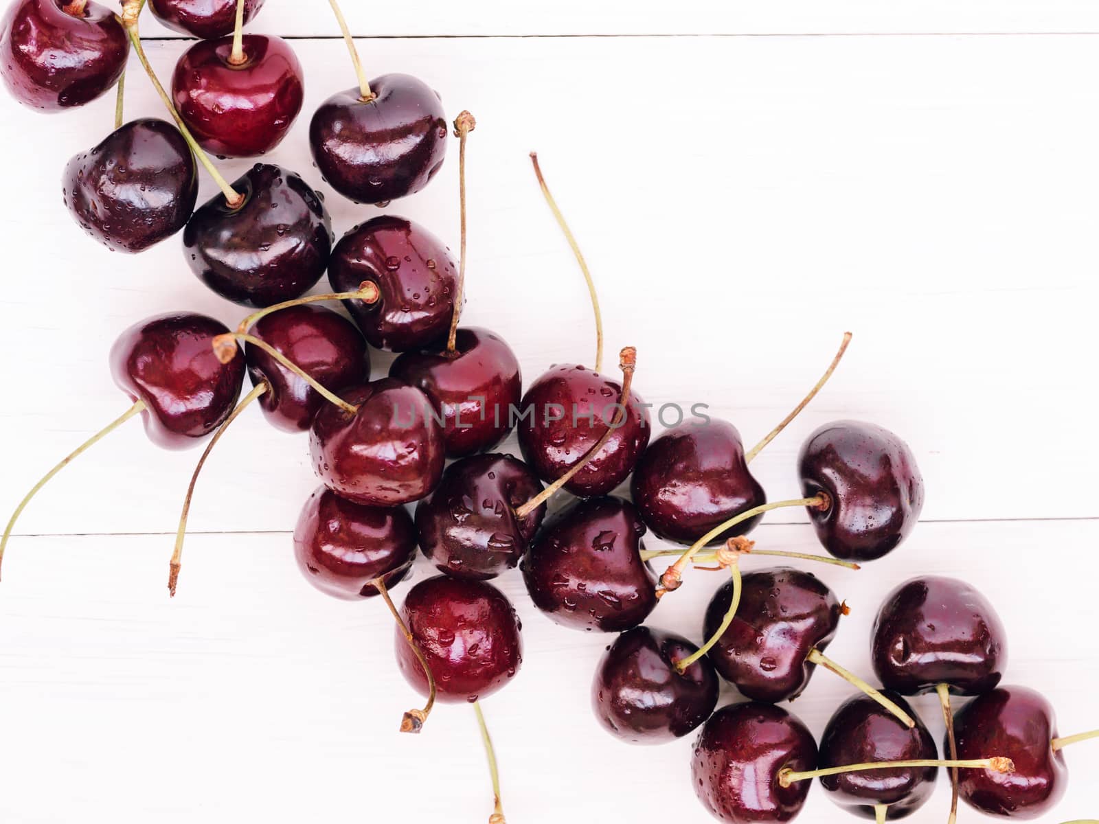 Ripe cherry on white wooden table. Top view or flat lay