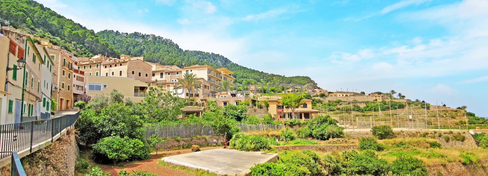 Banyalbufar, Spain - June 23, 2008: Panorama view over the village in the north of Majorca. Houses and hotels, square and terraced hill in front.
